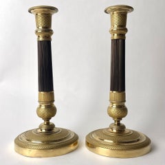 Elegant pair of French Empire gilt and dark patinated Bronze Candlesticks