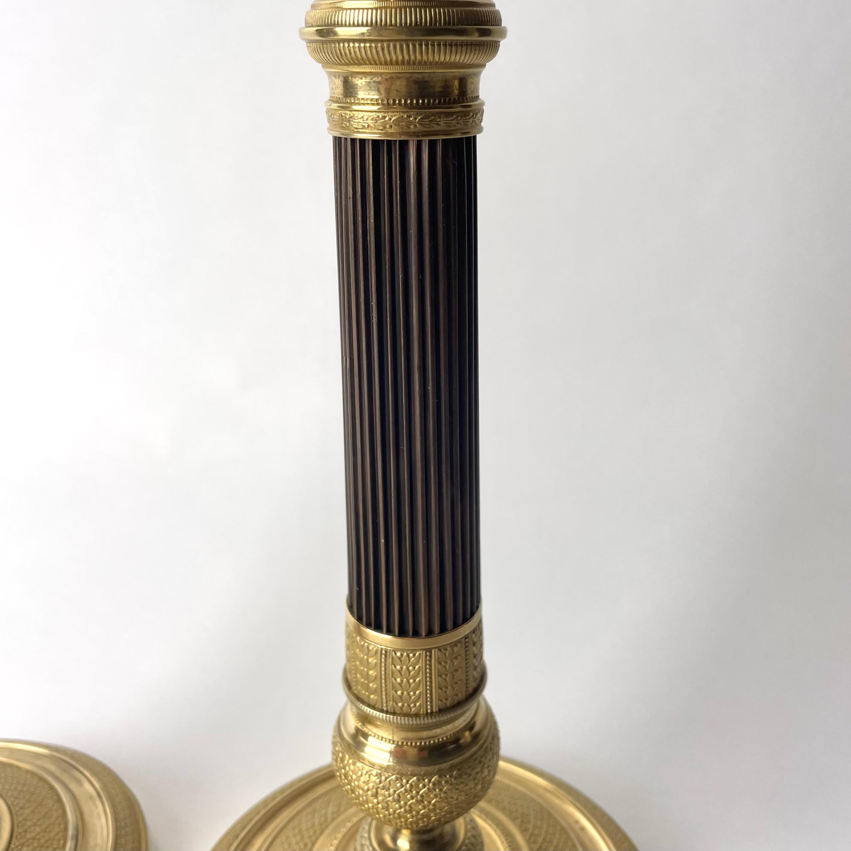 Elegant pair of French Empire gilt and dark patinated Bronze Candlesticks 1