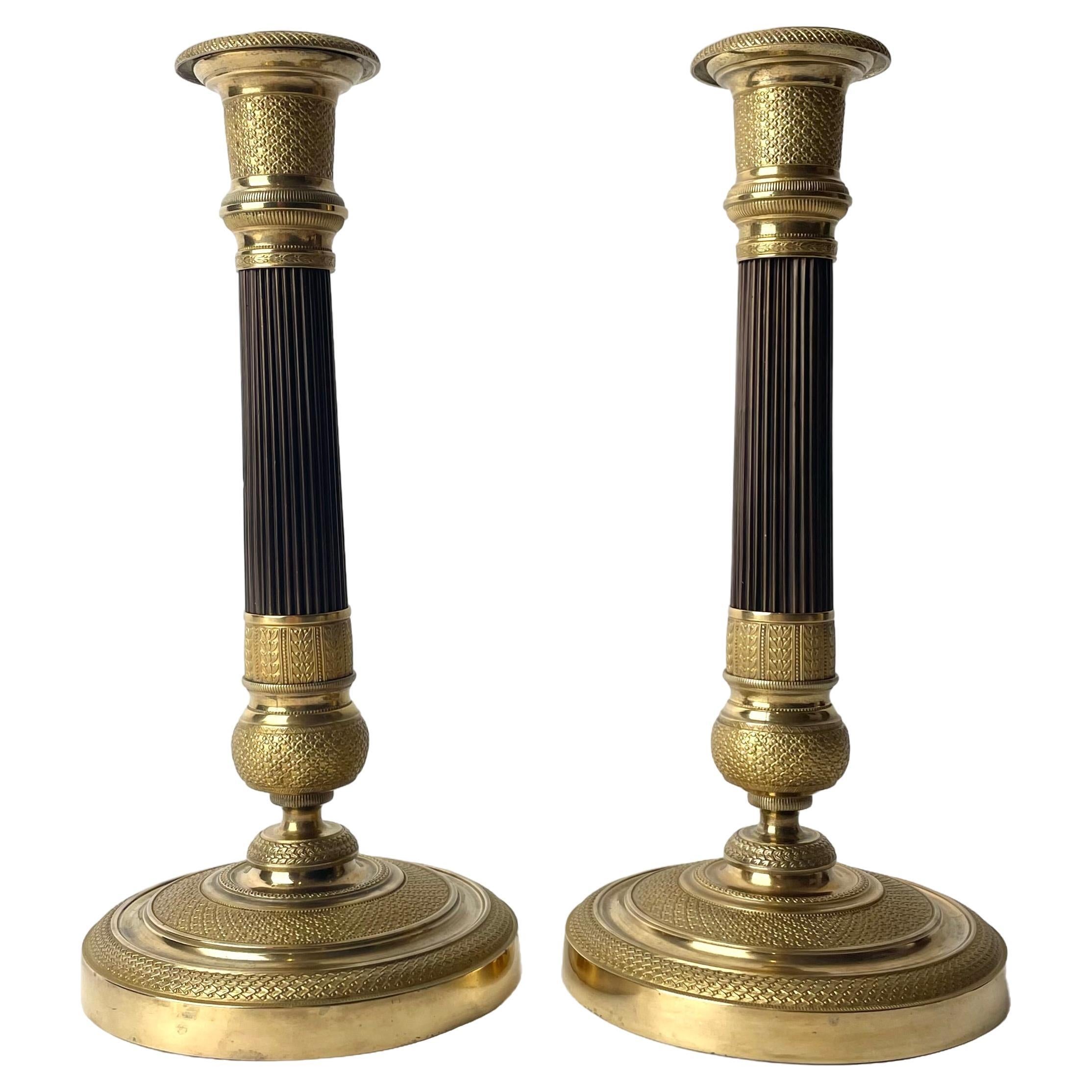 Elegant pair of French Empire gilt and dark patinated Bronze Candlesticks