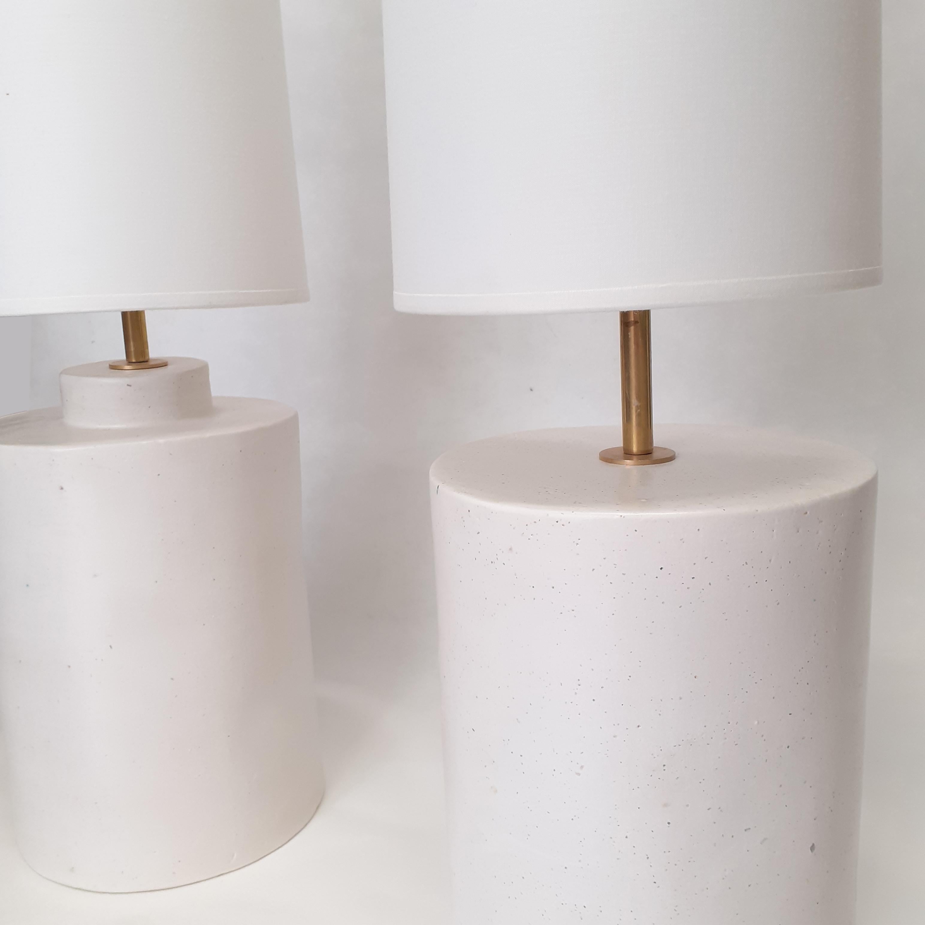 Very chic pair of ceramic lamps.
Handmade by Elsa Foulon Studio in her workshop at Paris.
Satin white enameled ceramic, brass structure and cotton shades.
  