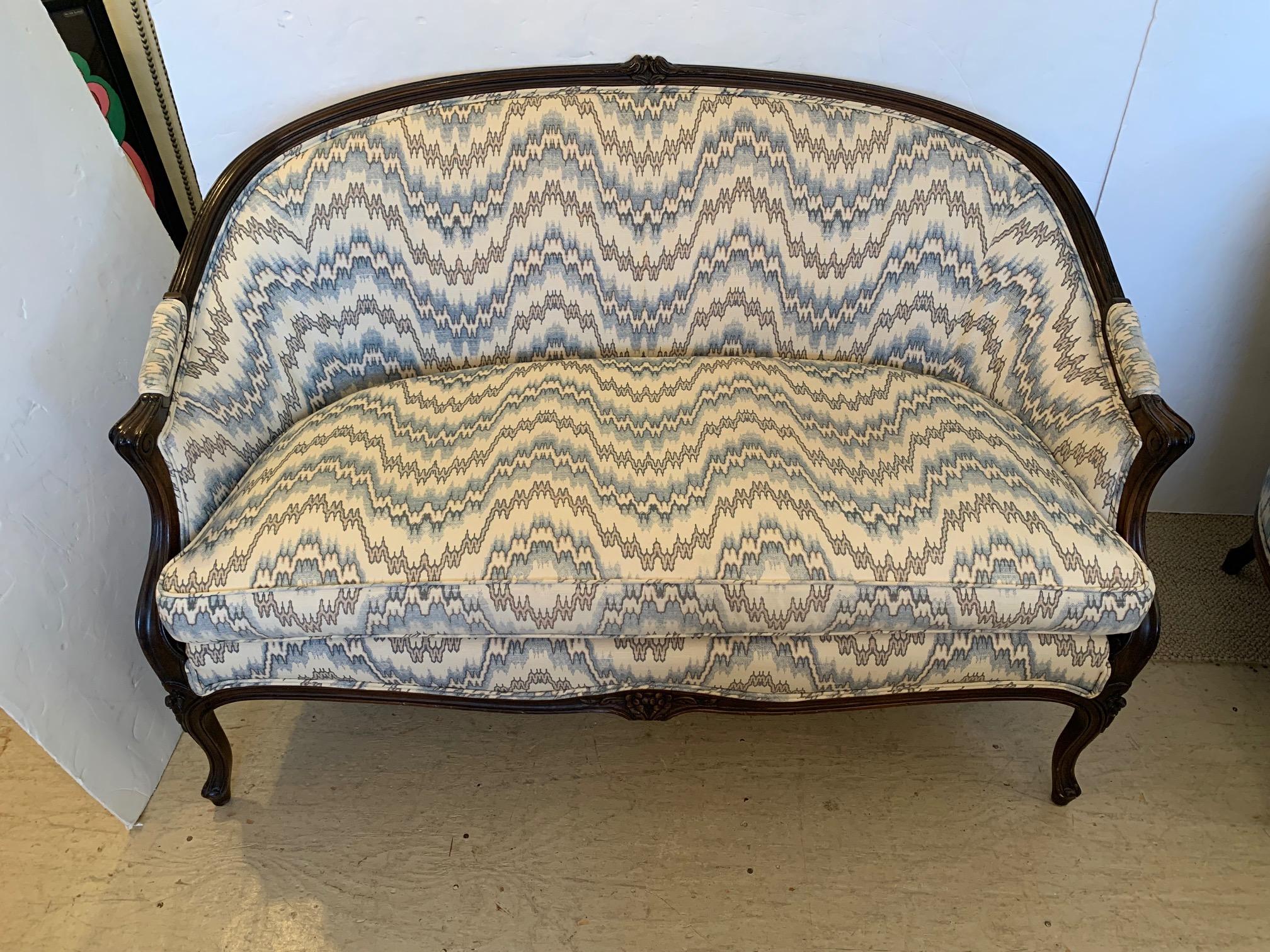 Lovely classic pair of carved walnut settees having curved backs and geometric flame stitch inspired linen upholstery.
Measures: Seat D 21
Arm height 26.