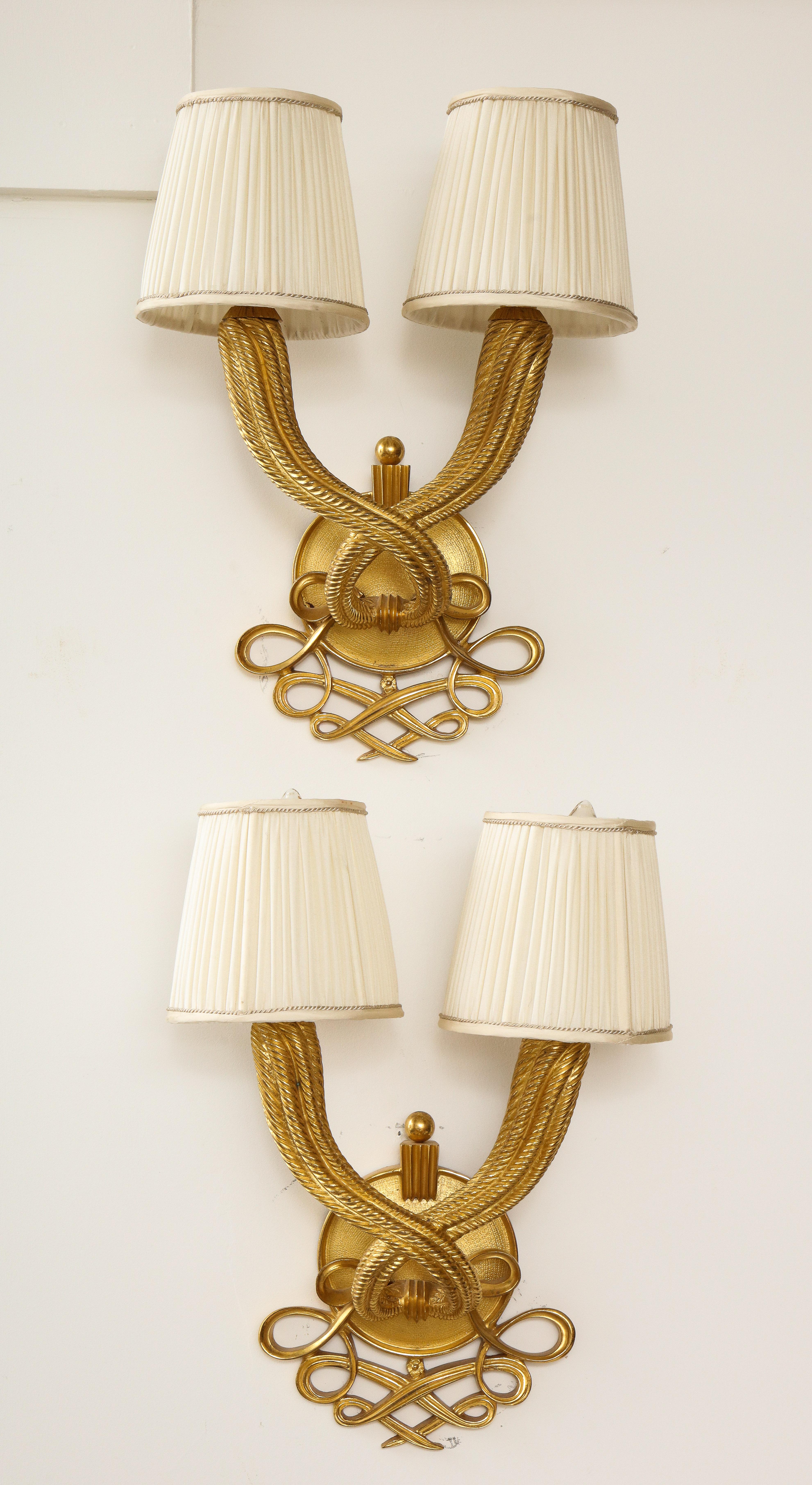 Elegant pair of Jules and André Leleu gilt-bronze double torsade two-light sconces. Stamped: 