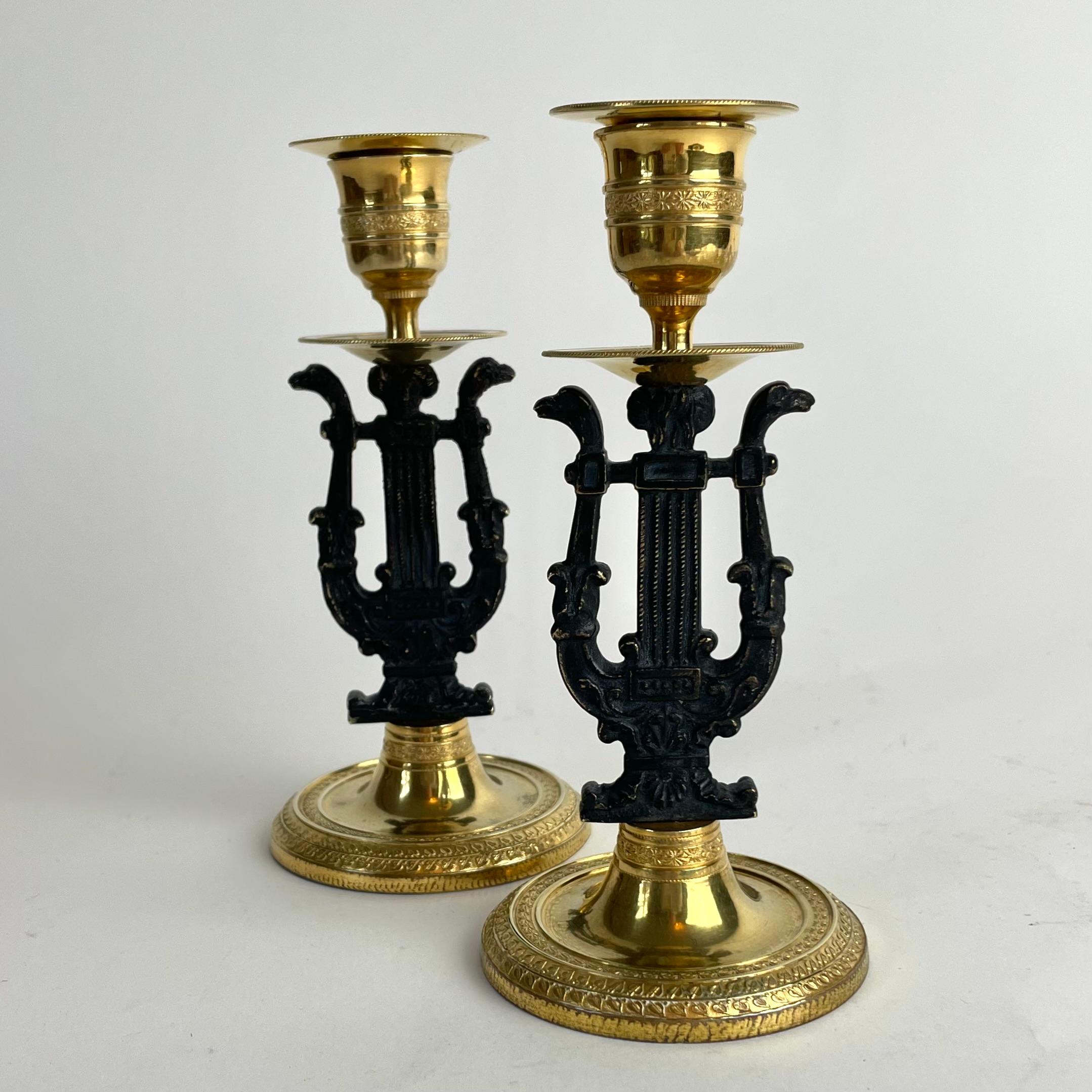 Elegant Pair of Karl Johan Candlesticks in Gilt and Dark-Patinated Brass, Sweden c. 1820s

A beautiful pair of Swedish candlesticks from the Karl Johan period — the Swedish interpretation of the Empire style — made around the 1820s. Crafted in gilt