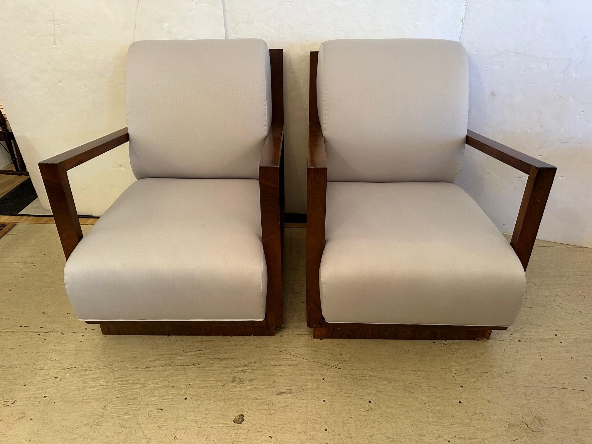 Pair of large elegant French antique Art Deco chairs having gorgeously grained mahogany frames, especially beautiful from the back, recently upholstered in neutral greige (greyish beige) cotton blend.

Arm: 24” H
Seat:  20.5” D x 15” H