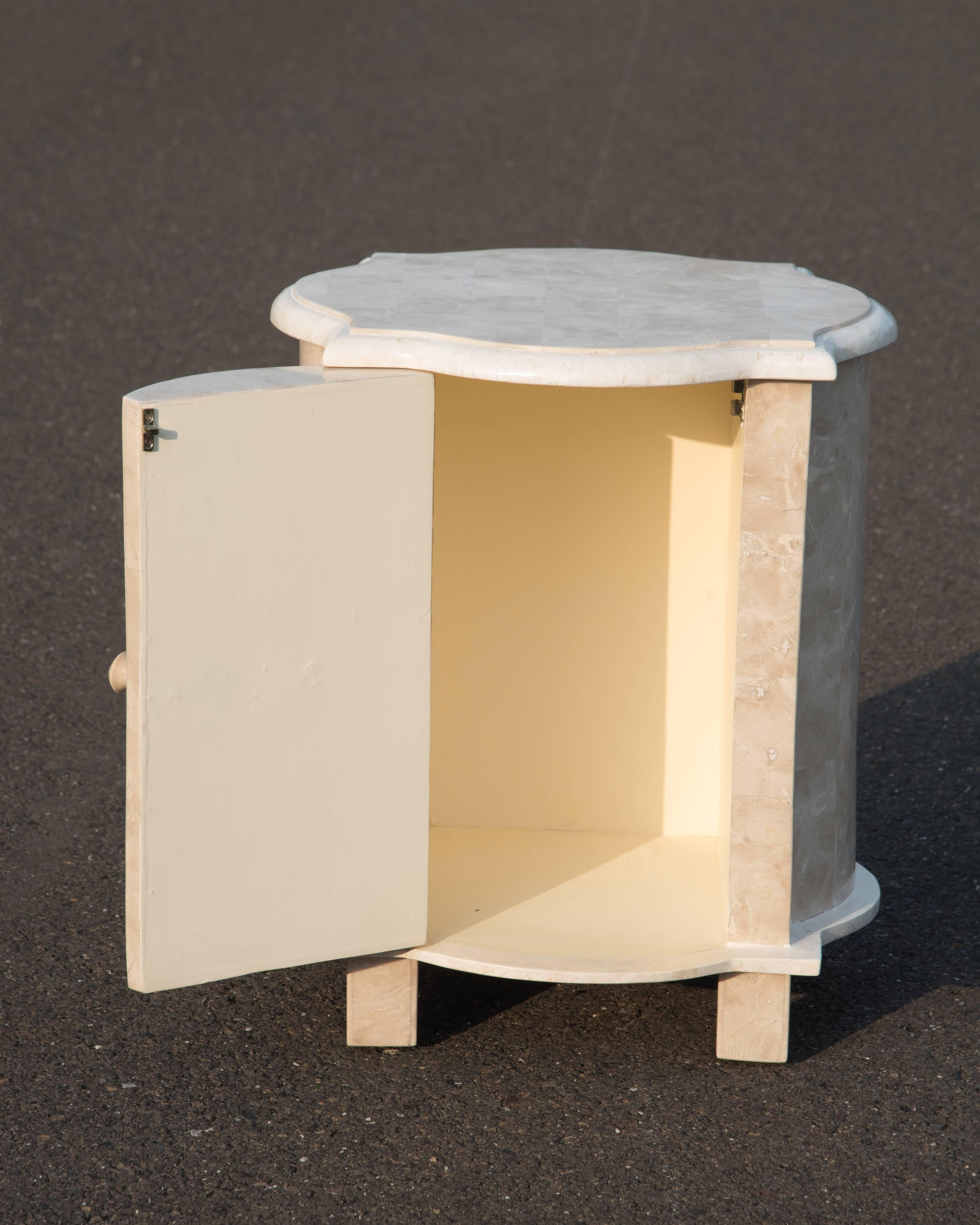 Two elegant beautifully crafted tessellated stone veneer end tables or night stands, one is a round drum shape trimmed with a brass ring at the base (measures H 25
diameter 19); the other has a Moorish design with single door which opens to storage.