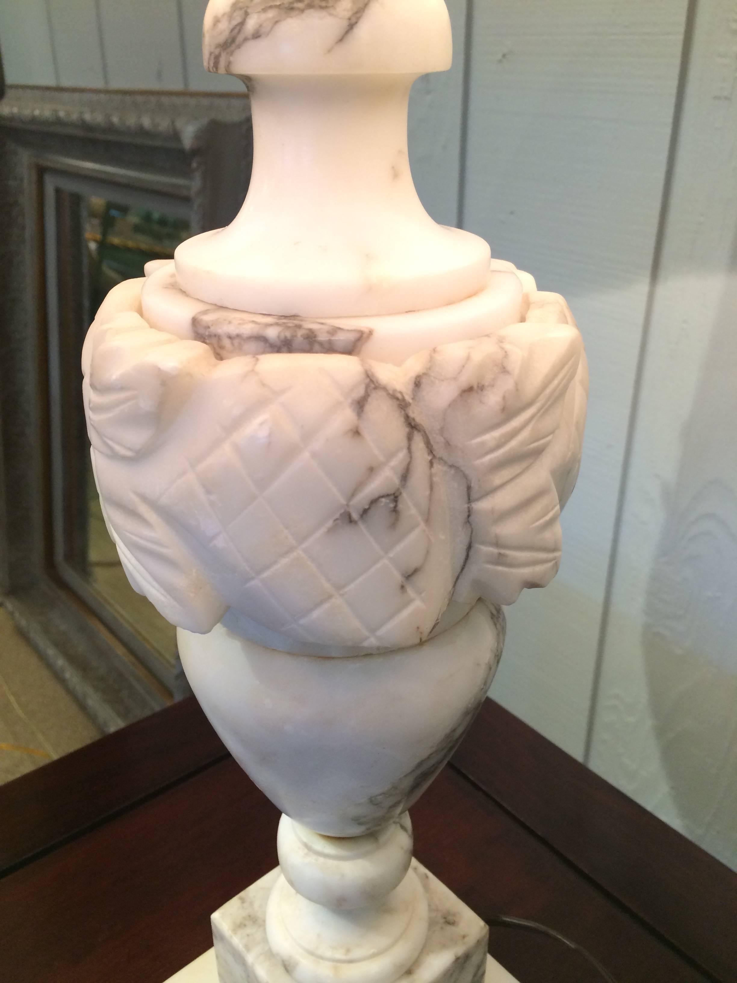 Two beautiful medium sized white and grey marble table lamps having gorgeous urn shape and decorative carving, including great looking custom sand colored linen shades.
Base is 4.5 square.