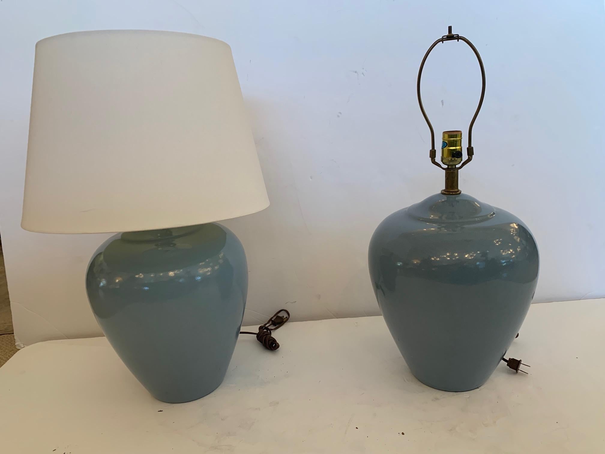 Lovely pair of Mid-Century Modern grayish blue pottery lamps with elegant urn shape and crazed surface. One lamp is a little bit darker than the other.
Shades not included.