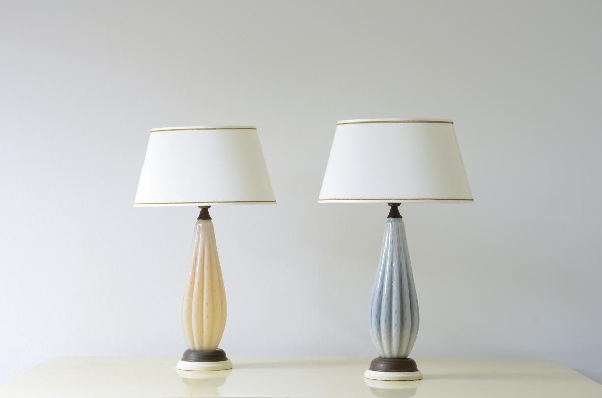 
COD-2600
Elegant pair of Murano glass table lamps in two different colors with an organic shape and ogival hat.

Murano manufacture 1950's