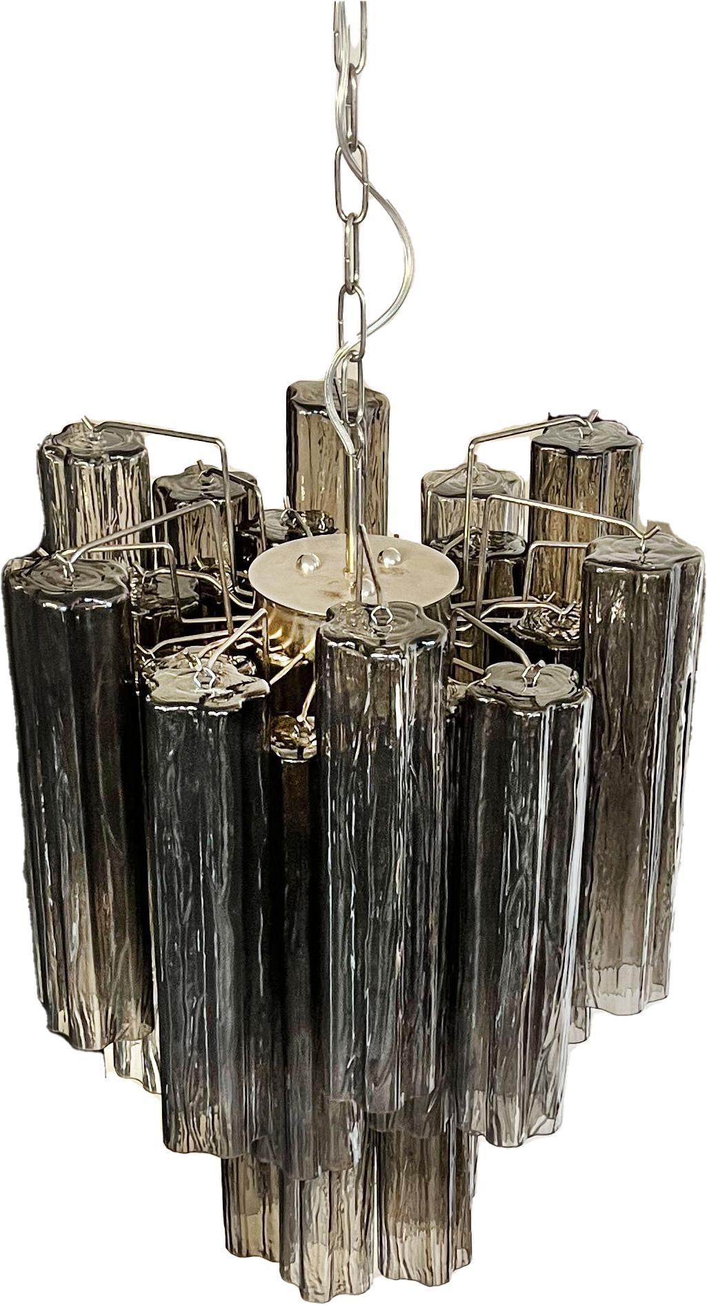 Italian vintage chandeliers in Murano glass and nickel-plated metal structure. The armor polished nickel supports 30 largesmoked glass tubes.
Period: Late 20th century
Dimensions: 47.25 inches (120 cm) height with chain; 24.80 inches (63 cm)