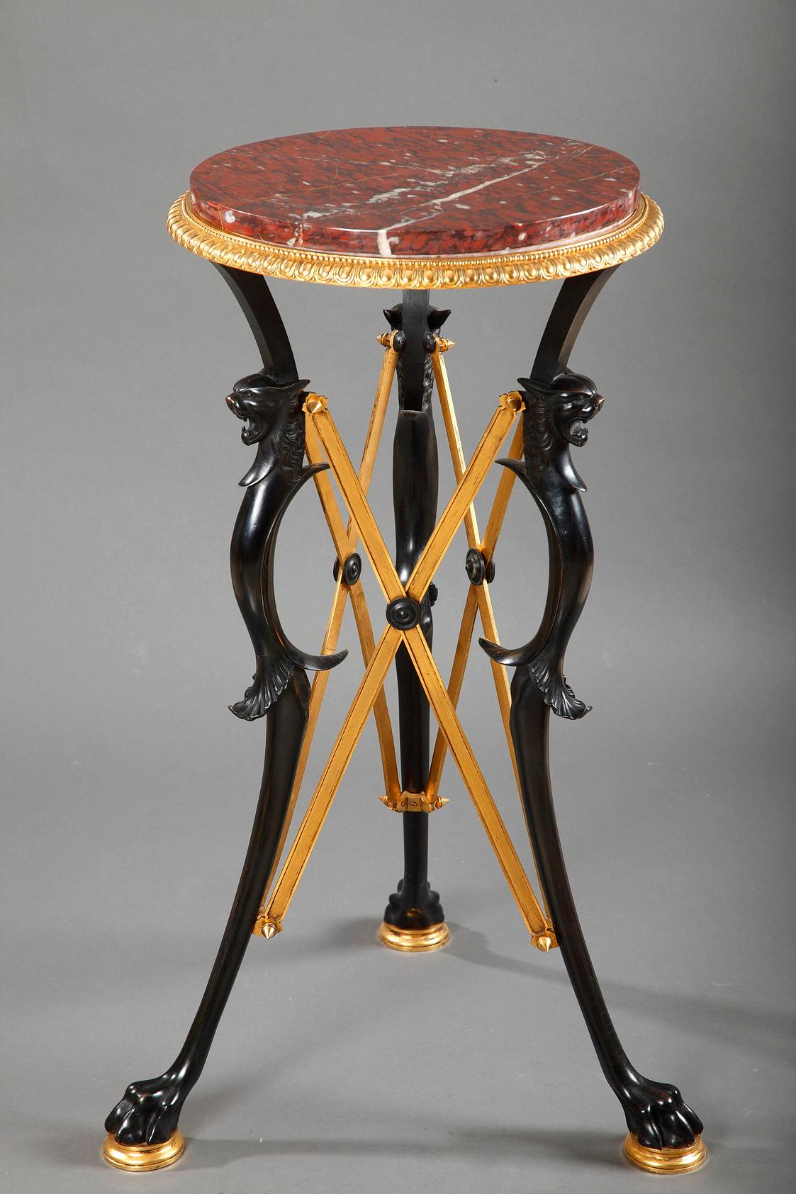 Pair of patinated and gilded bronze high guéridon attributed to L.C Sevin and F. Barbedienne, with for each of them, three paw feet joined by X shaped stretchers. Round red griotte marble top mounted with a bronze rim, adorned with ove and pearl