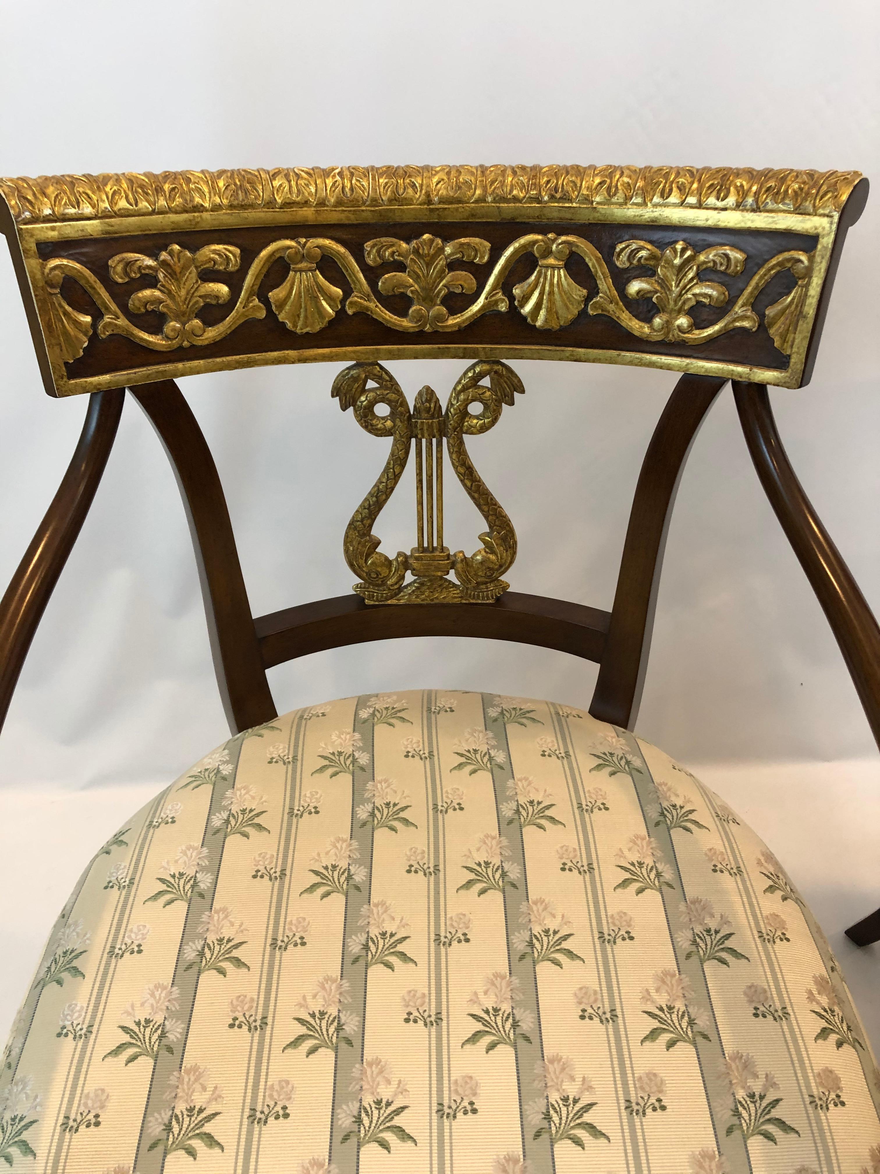 Magnificent pair of Regency style carved wood armchairs having gorgeous gold leaf decoration with lyre backs, florets on the arms and fabulous hoof feet at the front.
Arm height 26 (27.5 high at back of arm).