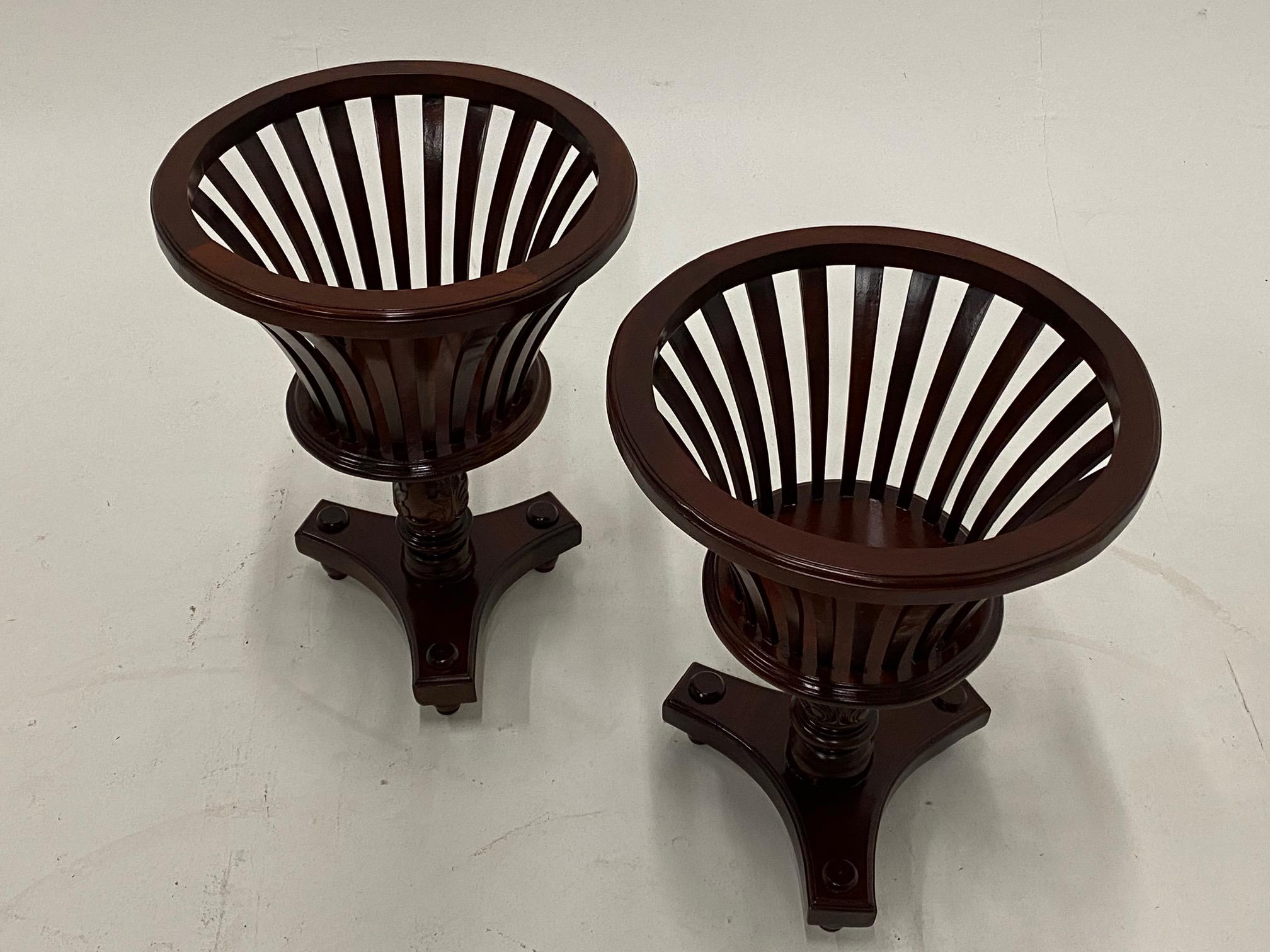 Rich mahogany pair of pierced plant stands having lovely carved wood columns and tripod bases.
Base is 14.5 square.