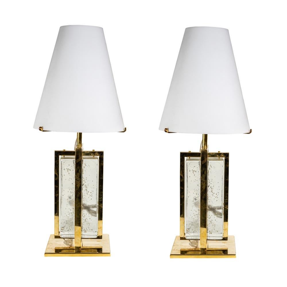 A very elegant pair of modernist table lamps. White satin blown glass shade in the form of a truncated cone mounted on a solid brass structure with a clear and gold inclusion blown glass shaped as a brick. Italian design 2000c. This pair of table
