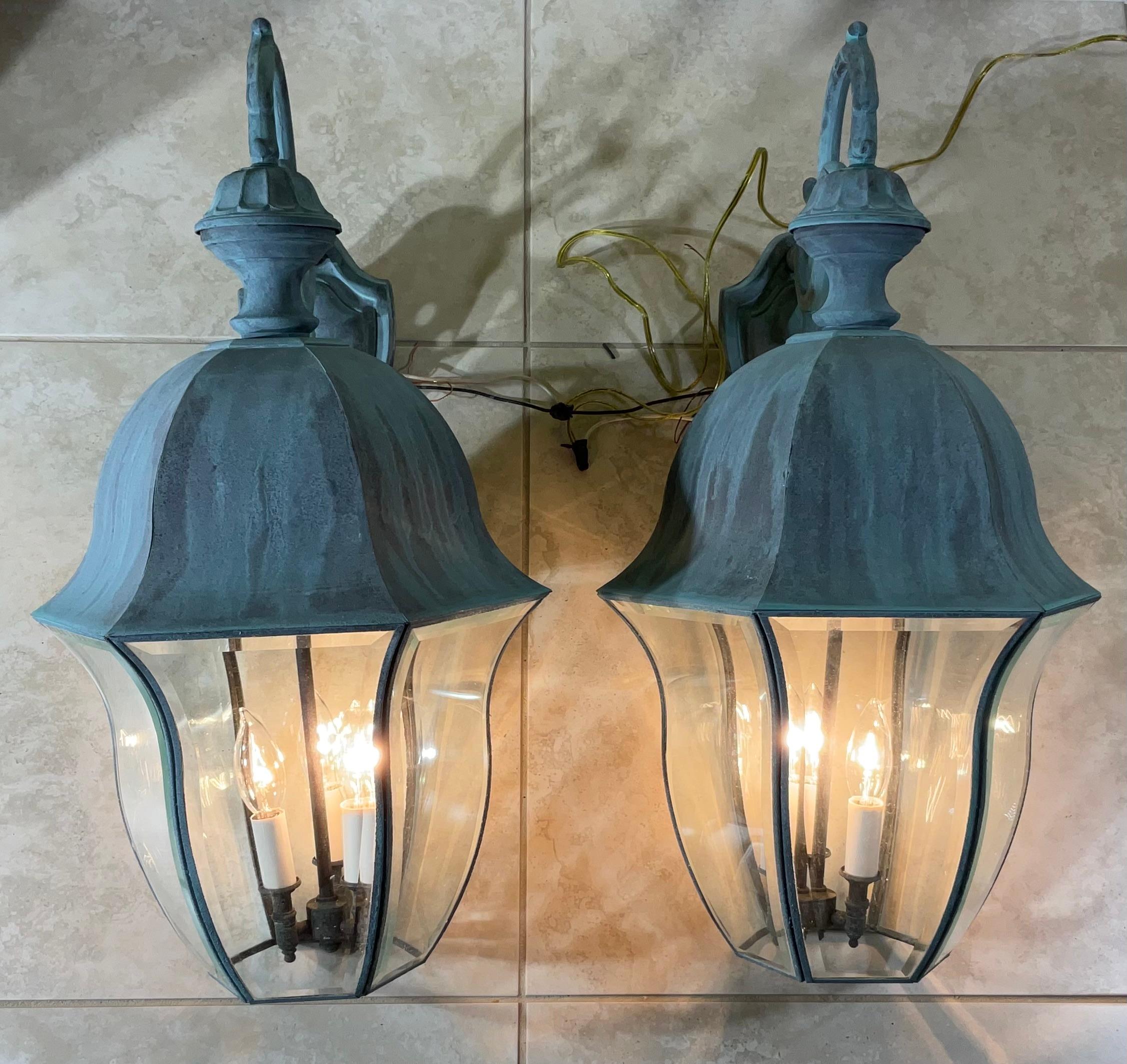 Elevate your home's curb appeal with this elegant , matching pair of large-scale, solid brass outdoor wall lanterns. Exuding timeless elegance and old-world charm, these high-end sconces are perfect for framing a grand entryway, flanking garage