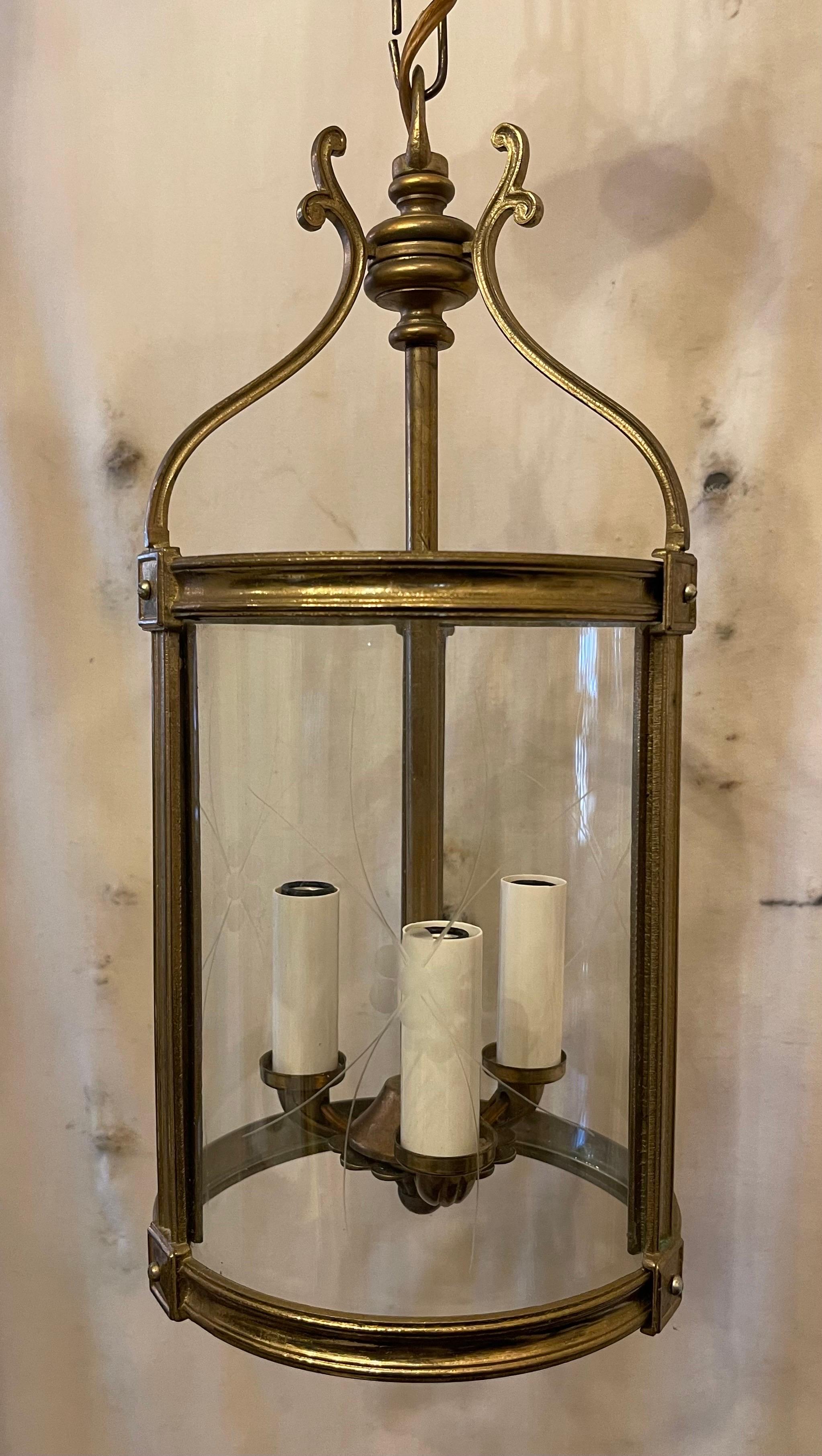 Elegant pair or Petite Bronze / brass Louis XVI Style Neoclassical Regency Lanterns Each Of The Fixtures Have A 3 Candelabra Light Cluster And Etched Curved Glass Panels. Accompanied By Canopy And Chain As Well As Mounting Hardware For