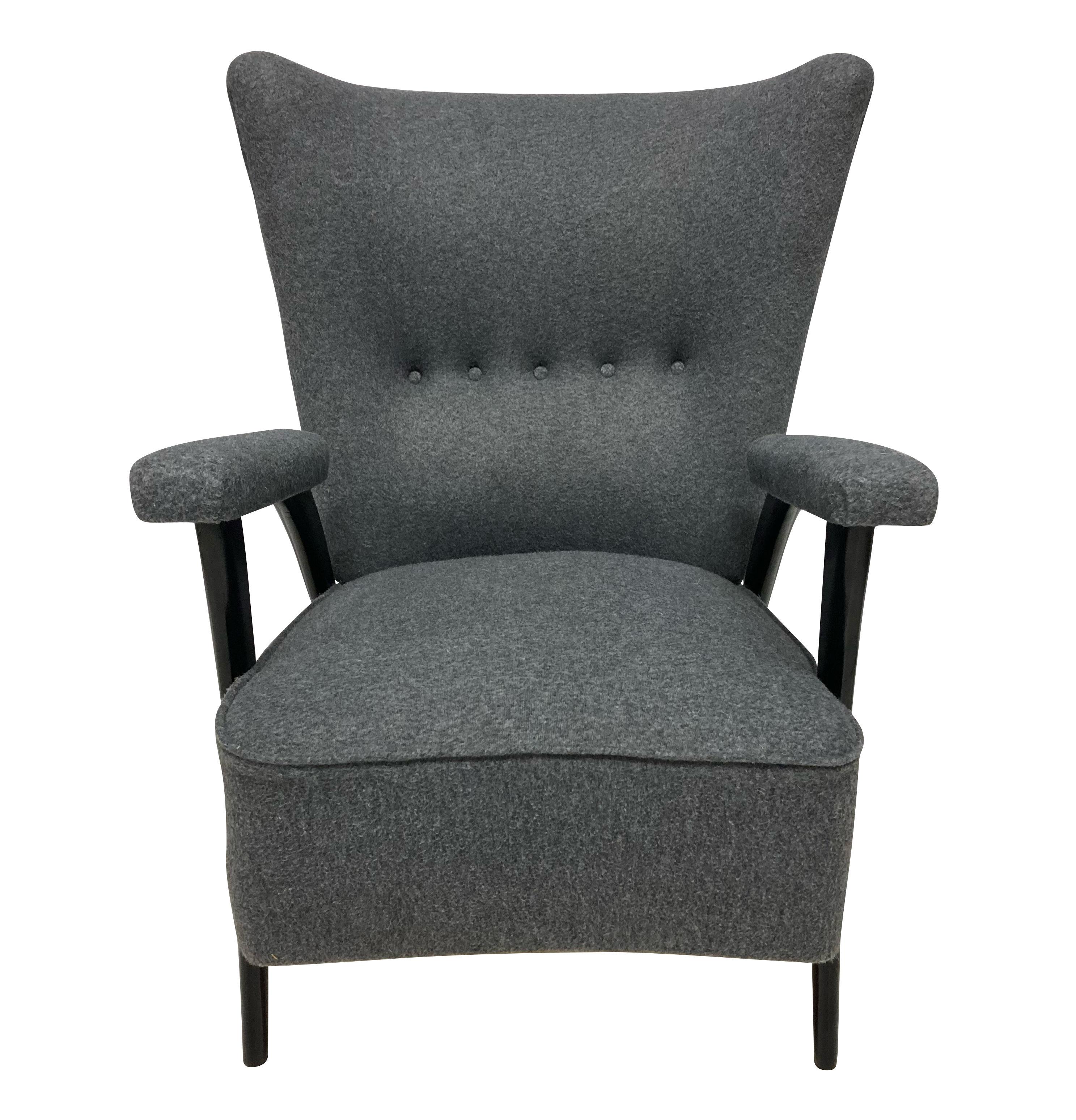 An Italian armchair of elegant design by Paolo Buffa. The architectural ebonised legs supporting a comfortable sprung seat and curved back, newly upholstered in grey wool.