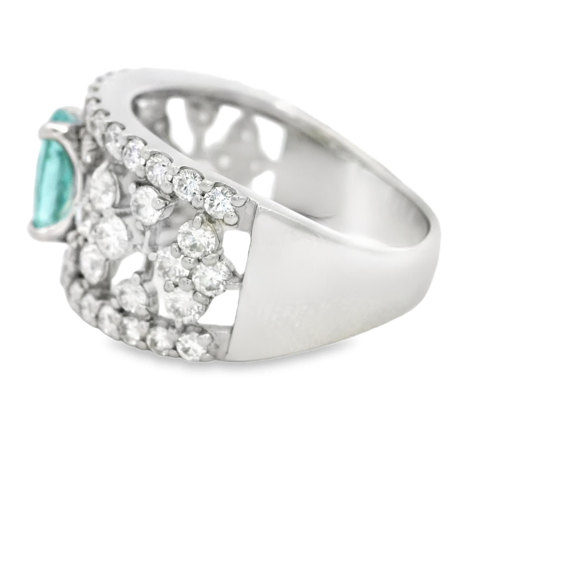 Discover the exquisite beauty of this elegant Paraiba Tourmaline and diamond ring. Featuring a stunning oval Paraiba centerpiece surrounded by a halo of sparkling diamonds, this piece is perfect for adding a touch of sophistication to any outfit.