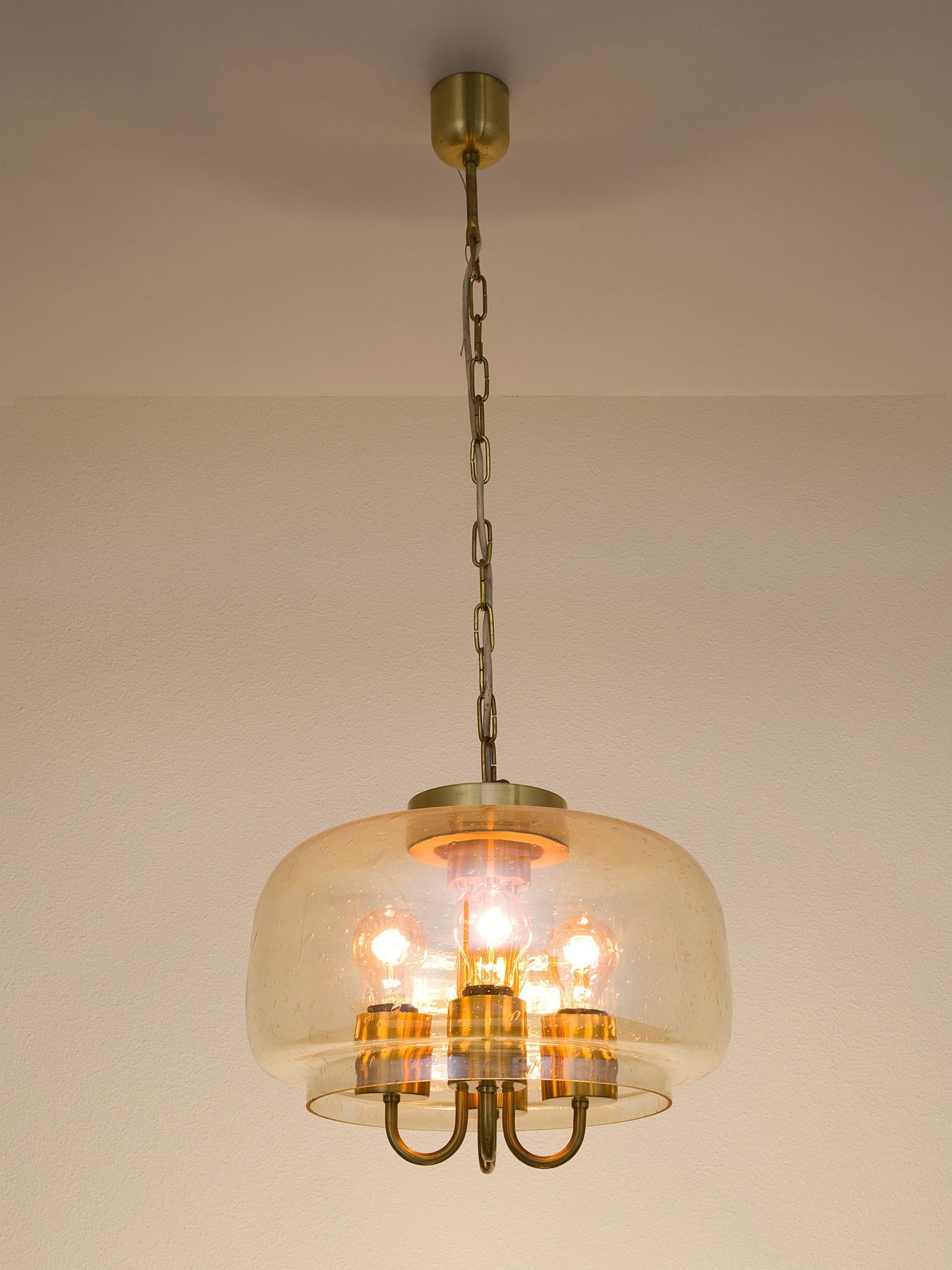 Pendant, in glass and brass, European, 1970s. 

Elegant pendant with round glass top. The raindrop glass is slightly colored. The structure and color make sure the light from the four bulbs is beautifully divided and create a stunning light