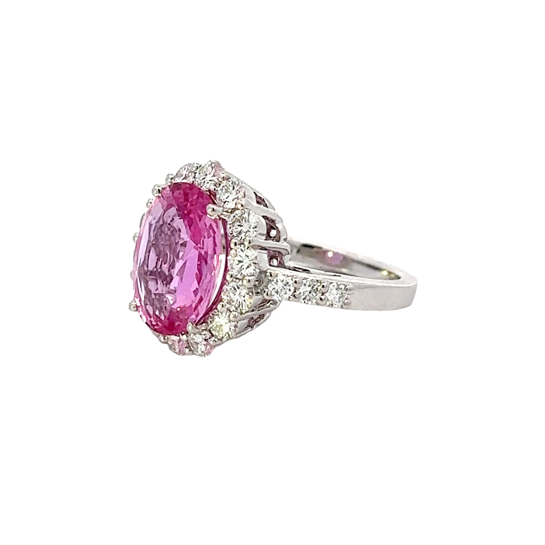 Discover the allure of this stunning pink gemstone ring, designed to captivate and enchant. The oval-cut pink stone is beautifully surrounded by sparkling diamonds, creating a perfect blend of elegance and glamour. Ideal for special occasions or as