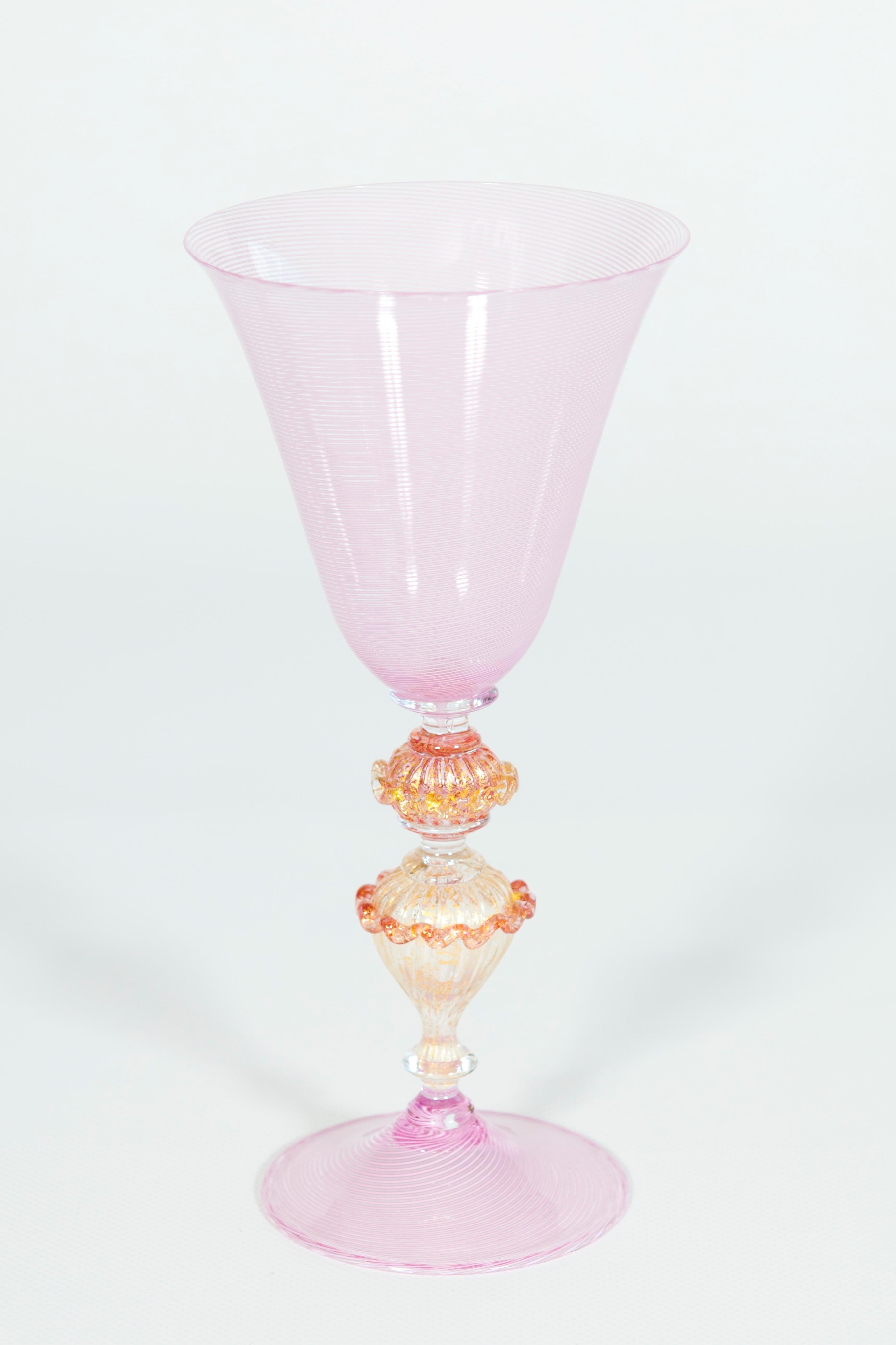 Elegant pink goblet in Murano glass with “Morise” decorations, Italy, 1990s.
This beautiful goblet, entirely made with blown Murano glass, stands out for its uniquely refined and elegant design. The base and the cup are made of pink blown glass