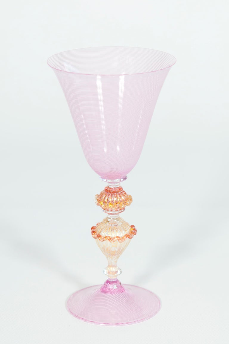 Elegant pink goblet in Murano glass with “Morise” decorations, Italy, 1990s.
This beautiful goblet, entirely made with blown Murano glass, stands out for its uniquely refined and elegant design. The base and the cup are made of pink blown glass