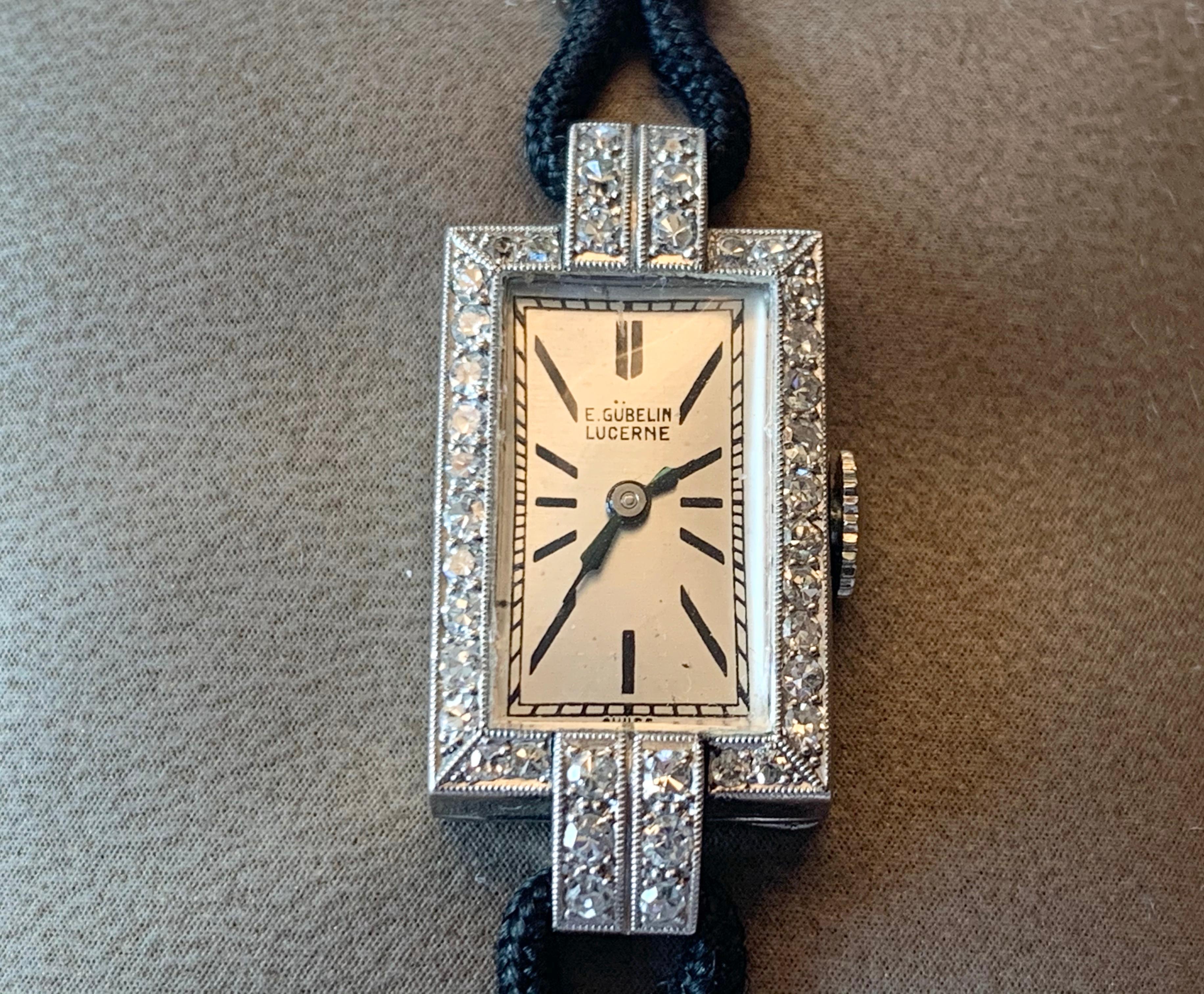 A stunning, fine and impressive antique cocktail wristwatch with Diamonds, signed by Gübelin. This stunning diamond cocktail watch has been crafted in platinum. This ladies wristwatch has a rectangular geometric form reflecting the typical Art Deco