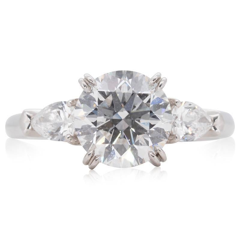 Stunning 3 stone ring made from Platinum with 1.92 total carats of round brilliant diamond and pear shape diamonds. This ring comes with a GIA Certificate and a fancy Harry Winston box.

-1 diamond main stone of 1.59 ct. 
cut: round brilliant
color: