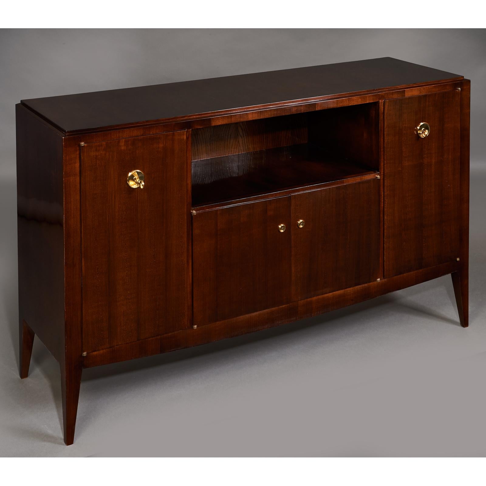 Jules Deroubaix (1904-1979)
An elegant four door cabinet in mahogany stained fruitwood with central open niche,
polished brass mounts.
Signed, maker's stamp on back
France, 1950s
Dimensions: 59 W x 18.5 D x 37 H.
 