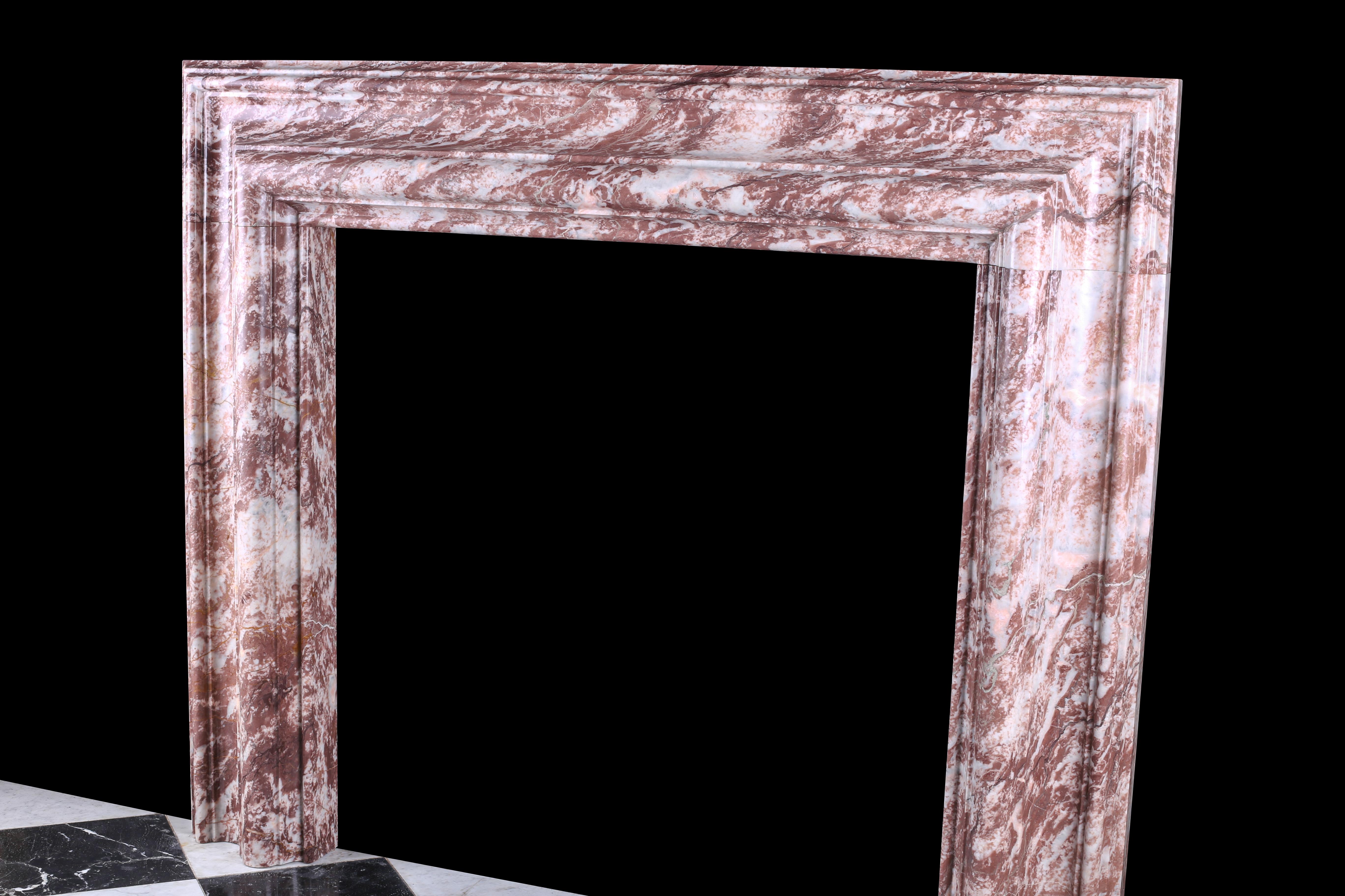 An elegant Regency Baroque Bolection fireplace surround in Italian Fior di Pesco marble.

Measures: Depth 5