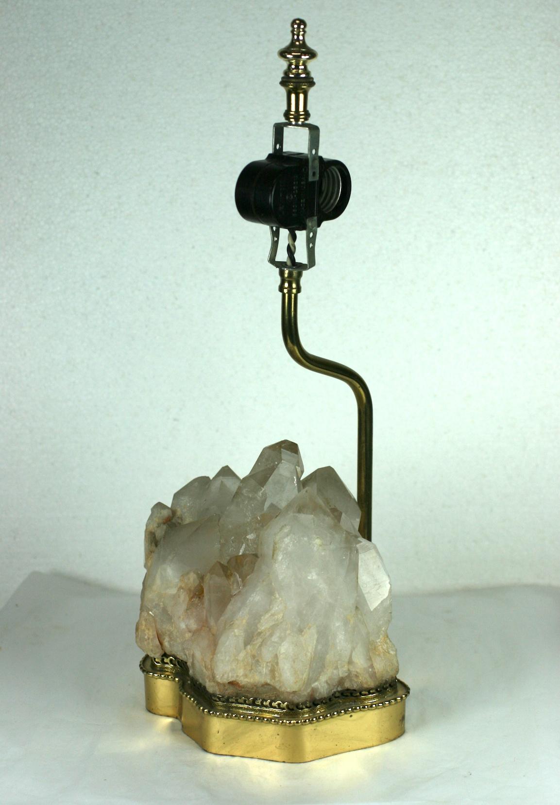 Rock crystal quartz lamp on brass base set within a filigree gallery with period wiring. Classic elegant and timeless design.
Place for 2 bulbs. Lacking shade. Original wheel switch, 1960s.
Measures: Total height 17