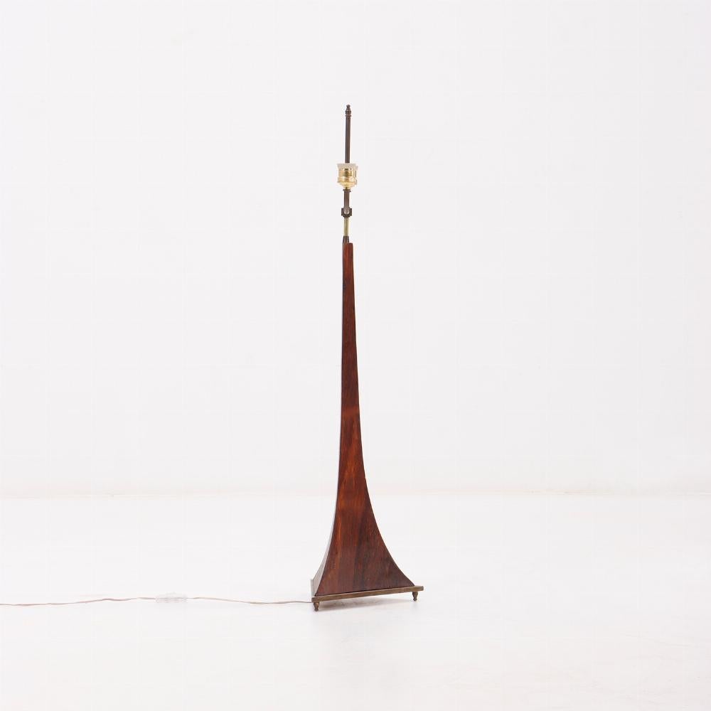 Elegant rosewood and bronze table lamp circa 1960. Having round shade over a flaring triangular base supported by a bronze footed base. 