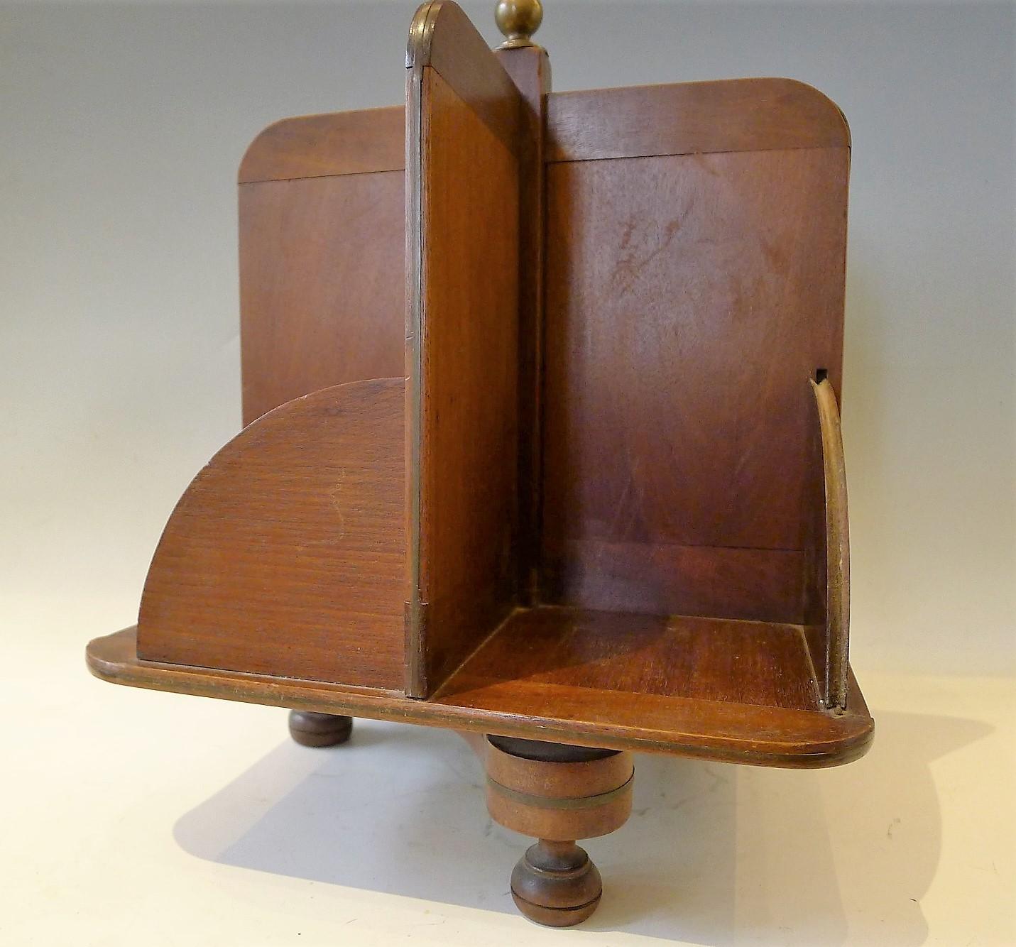 Unusual bookcase for a desk, a table even a bookshelf

Thin mahogany panel and rounded tripod with decorative brass

  