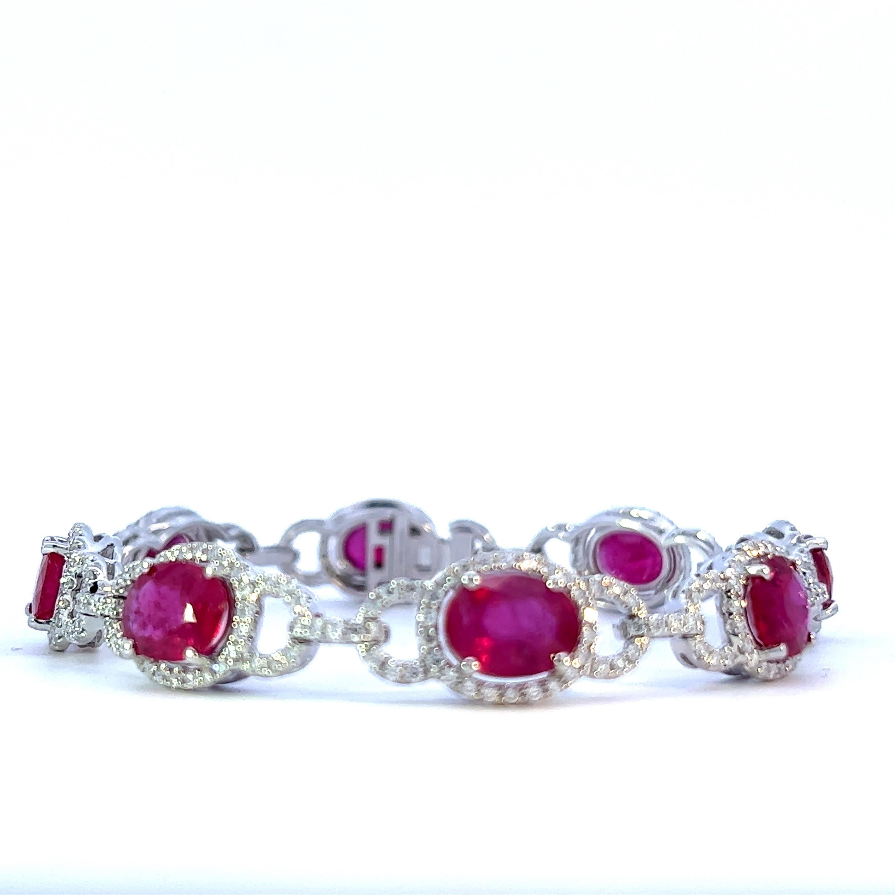 This stunning ruby bracelet features a series of exquisite oval rubies, each surrounded by sparkling diamonds. The intricate design showcases a perfect blend of elegance and sophistication, making it a must-have accessory for any jewelry lover.