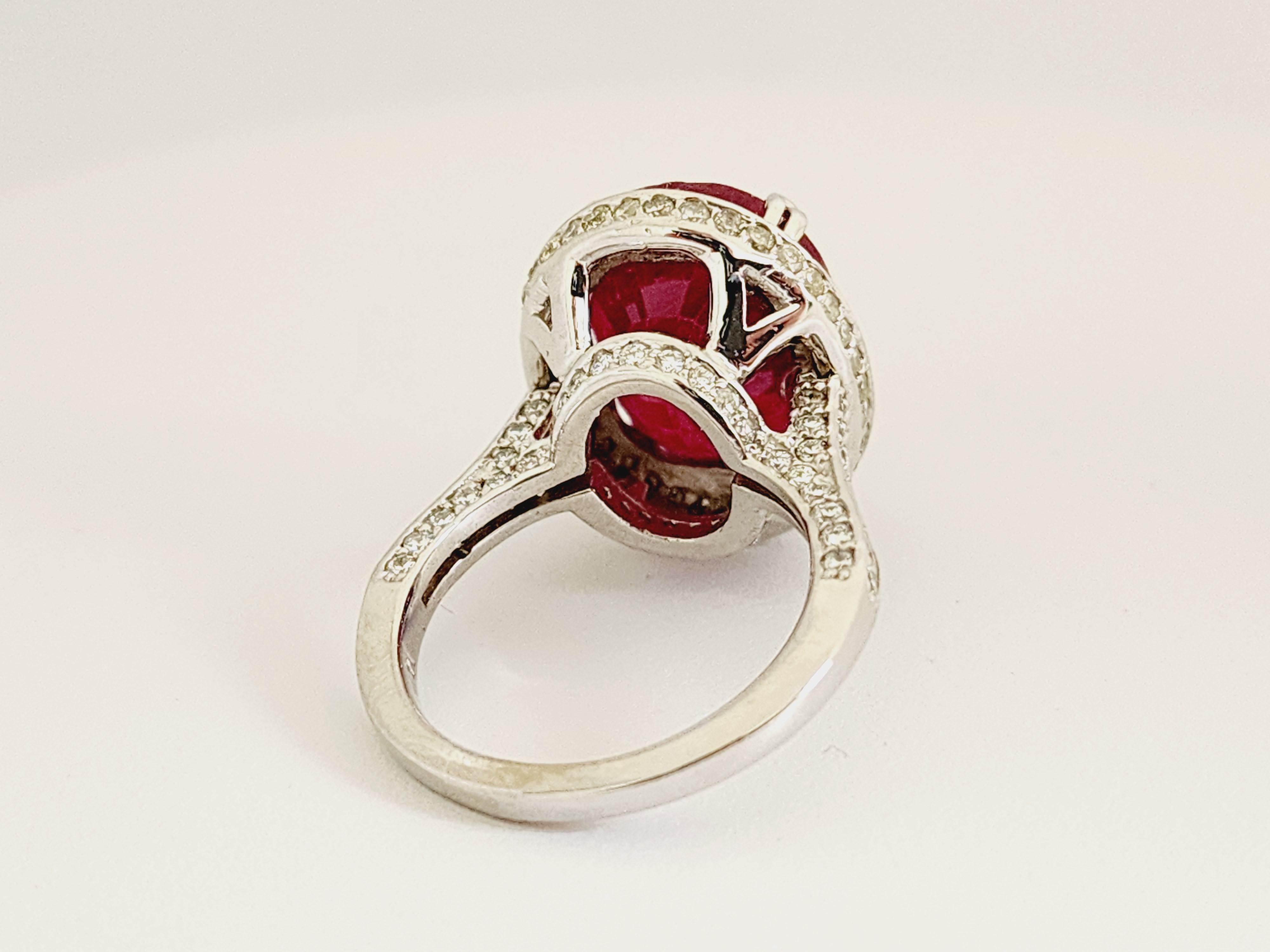 Genuine Ruby oval shape surround by natural diamonds on the ring 14K white gold. Unique, Brilliant, and Beautiful.

Ruby Size: 13.82 ctw Glass Filled
Diamonds: 2.35 cttw Average I-SI
Ring Size: 7
