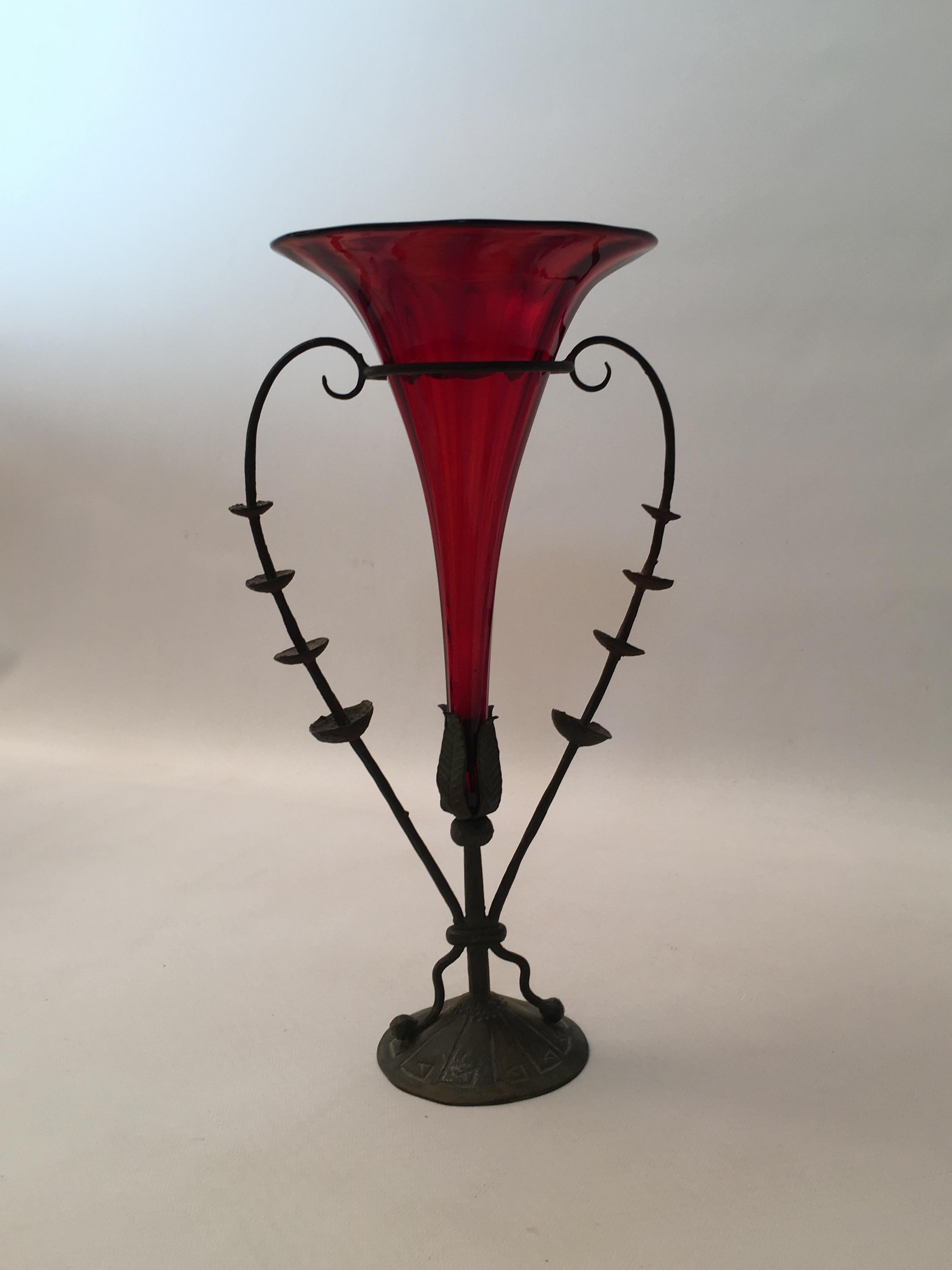 Distinct and elegant ruby red flared glass vase with heart shaped metal holder. The piece is attributed to Vittorio Zecchin (1878-1947). The metal base is signed, Made in Italy.

Measures: 10.5