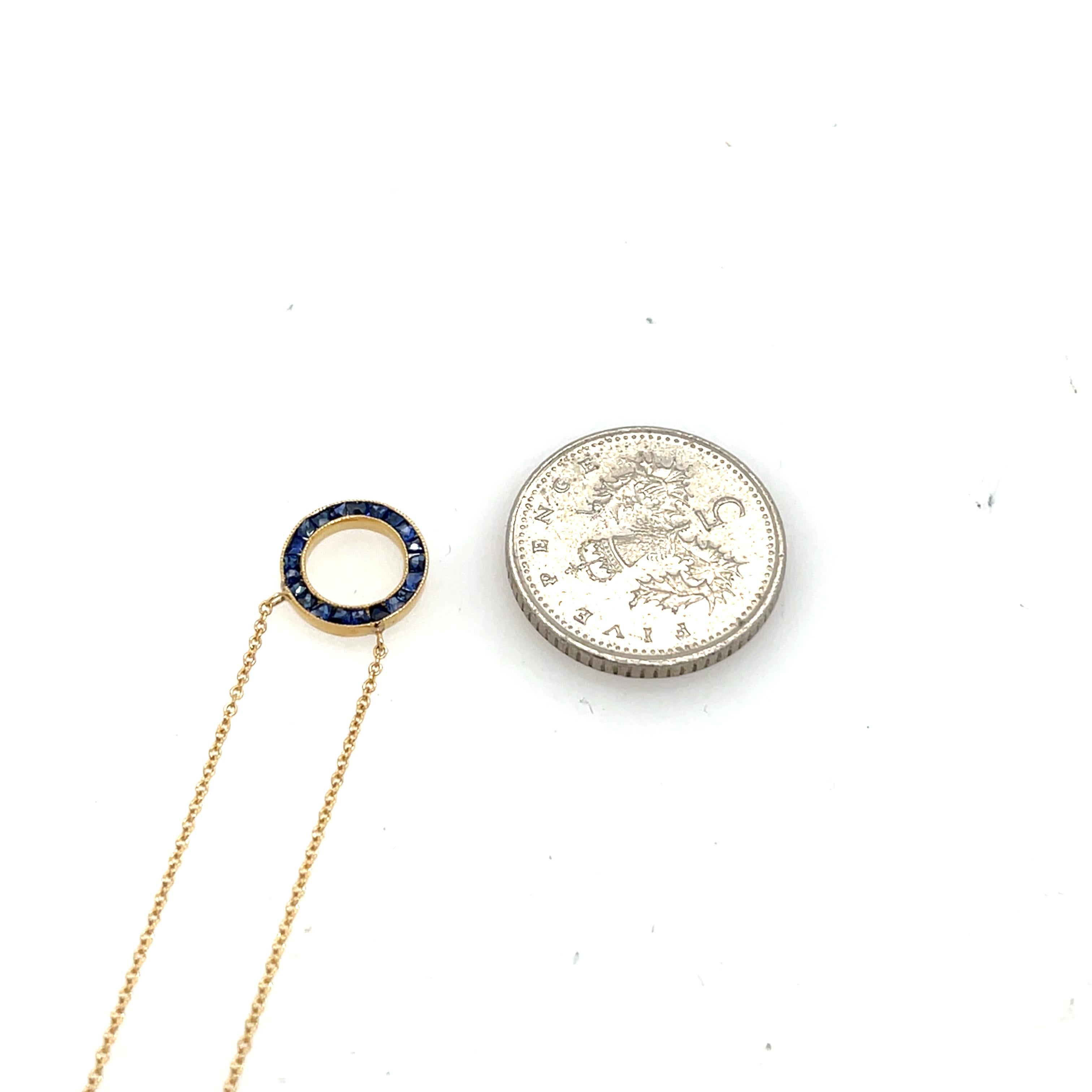 An elegant Circle of Life pendant crafted in 18ct yellow gold, beautifully adorned with sparkling square natural sapphires. A timeless design symbolizing eternity and unity.

Chain Length: 18