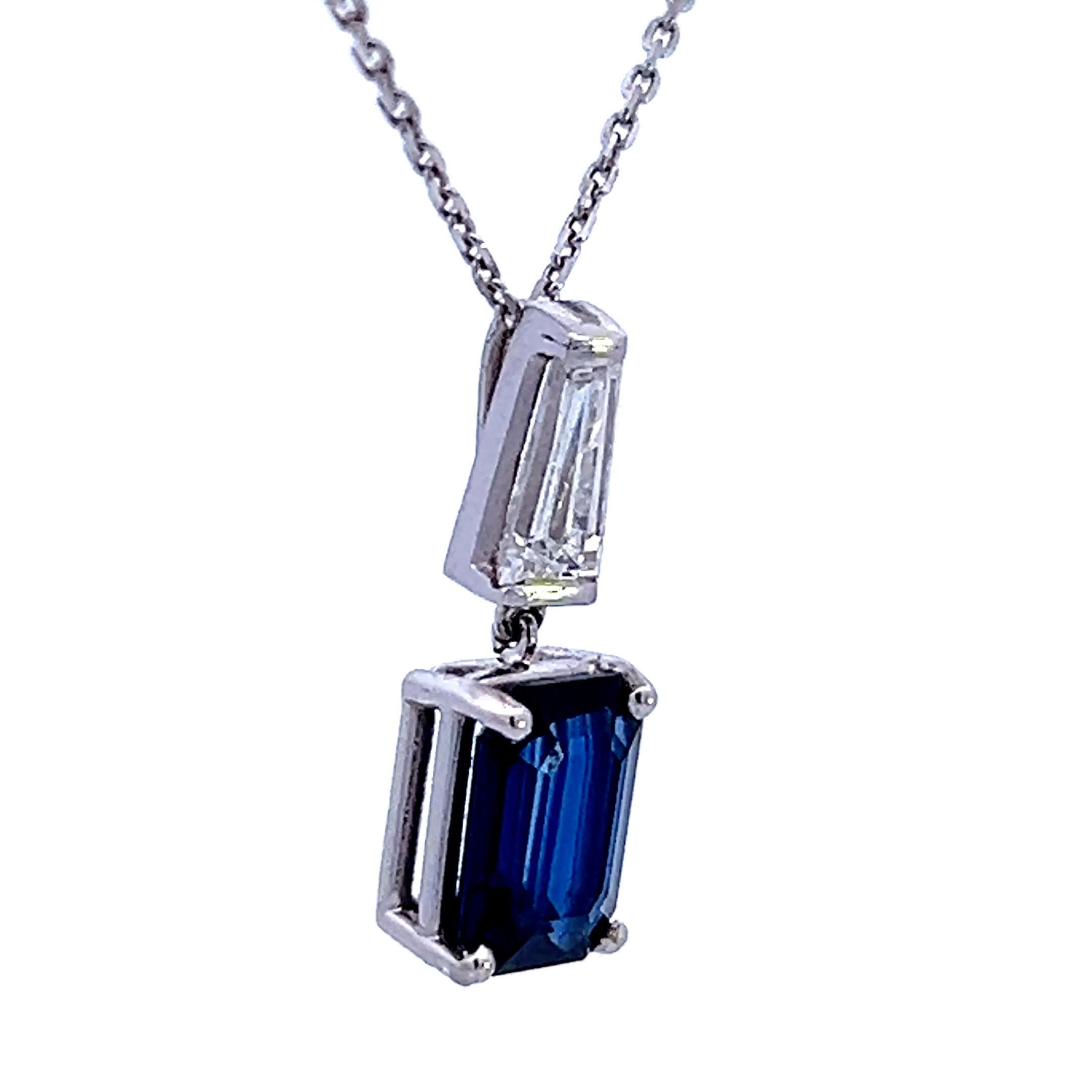 This exquisite pendant features a stunning deep blue sapphire, elegantly set in a sleek silver chain. The sophisticated design is enhanced by a sparkling white gemstone above the sapphire, making it perfect for both everyday wear and special