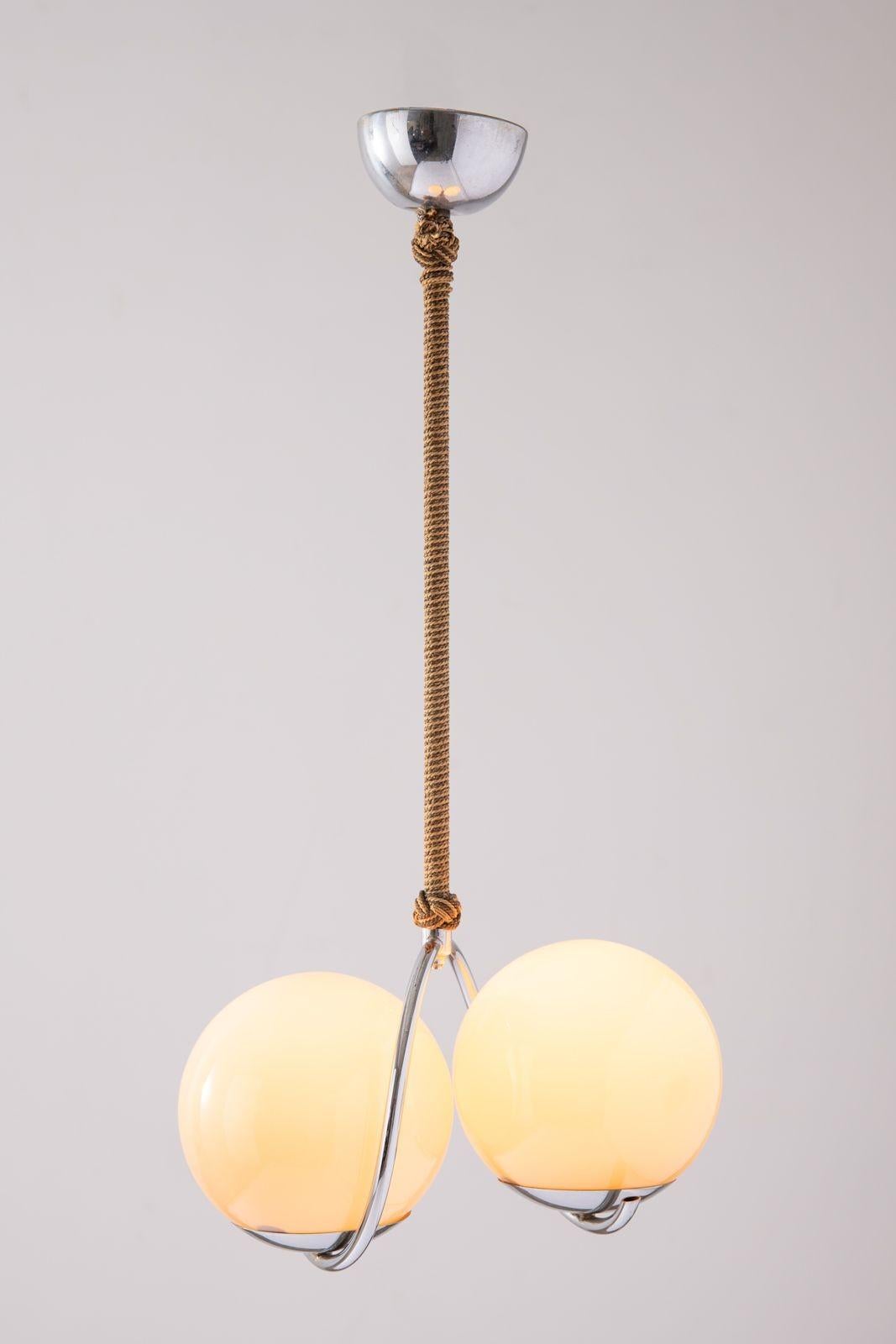 This elegant pendant lamp is very sensual and pleasing to the eye.
It was purchased on a trip to Denmark in the 1960s and is crafted of the highest quality materials. The lamp has been very well preserved. Due to the flesh tone of the glass globes,