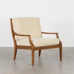 Elegant Scandinavian Teak armchairs with creme coloured cushions