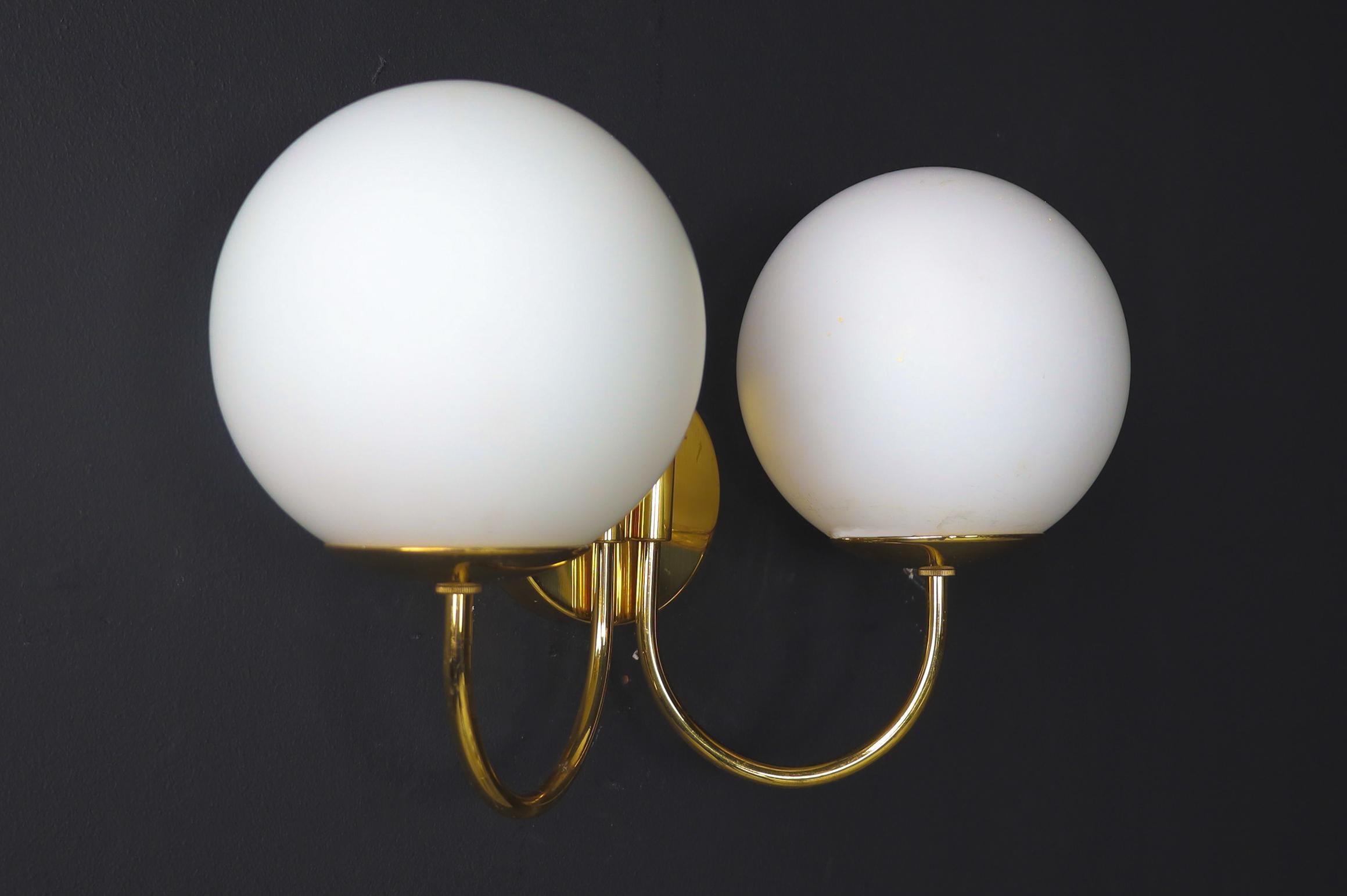 Elegant sconces with brass fixtures and opaline glass globes, Italy 1960s

A large set of wall lights/sconces with a brass fixture was produced and designed in Italy in the 1960s. The pleasant light it spreads is very atmospheric. Completed with
