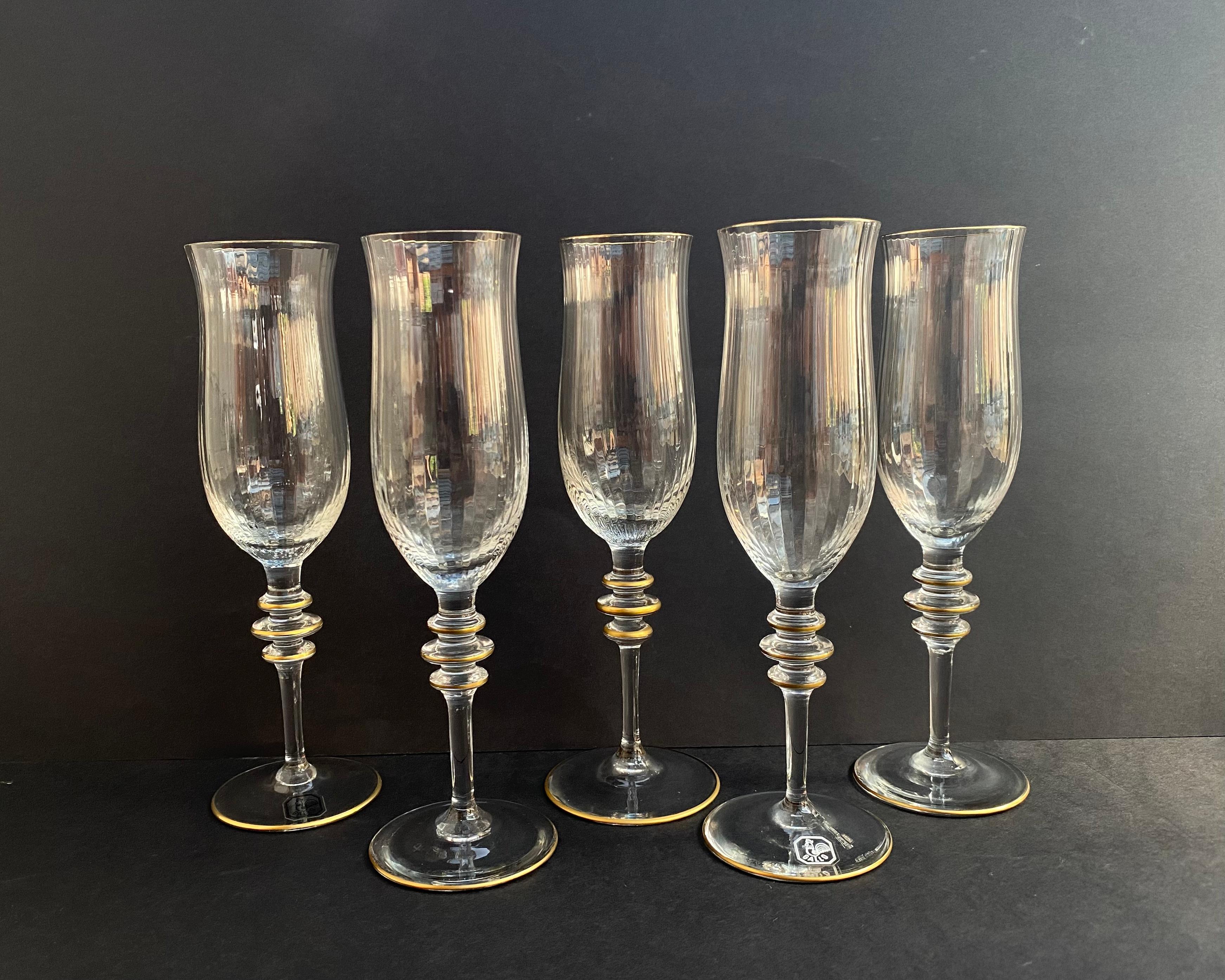 Elegant Rare Set of 5 ice effect Crystal Glasses with gilding and embossed surface by German manufactory Gallo. 1980s.

Products are equipped with high legs and are designed to serve champagne, wine or other liquids.

The glasses are hand-cut