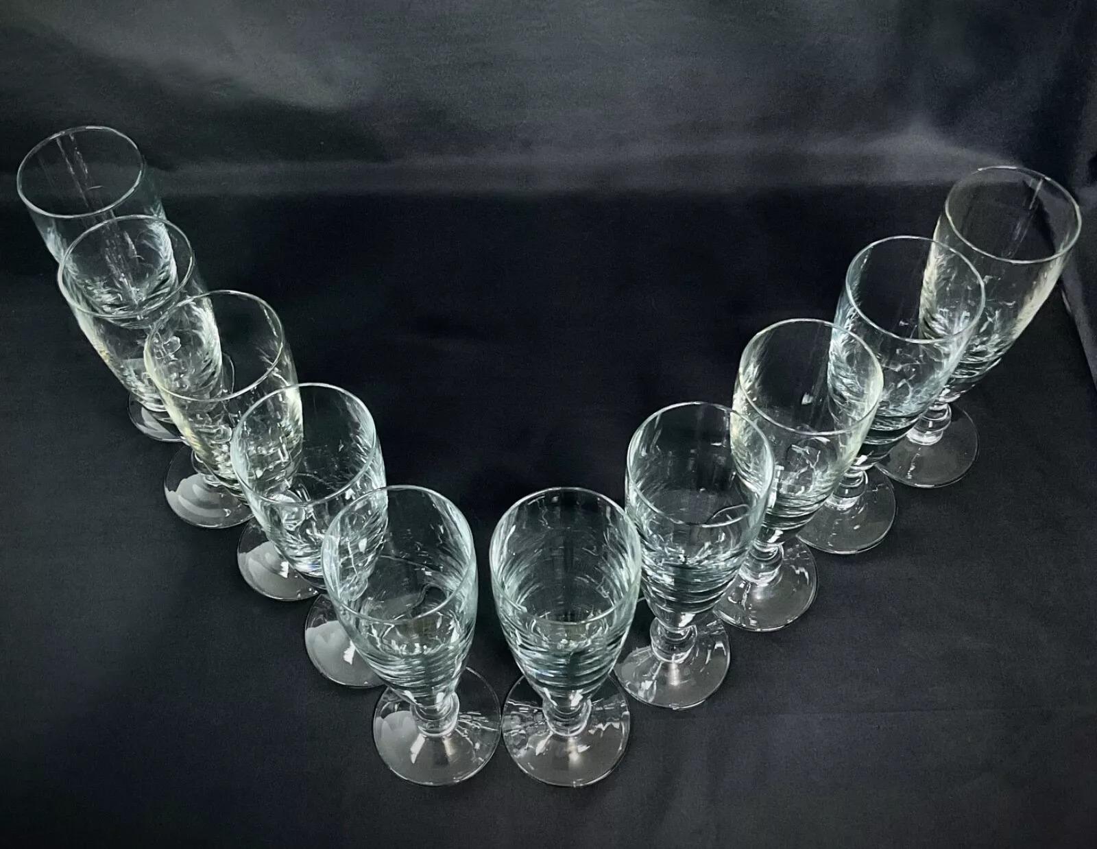 This exquisite vintage set includes ten crystal wine glasses, each standing tall at 24.5 cm and crafted with fine attention to detail. Their elegant design, with a refined shape and impressive clarity, makes them a sophisticated addition to any