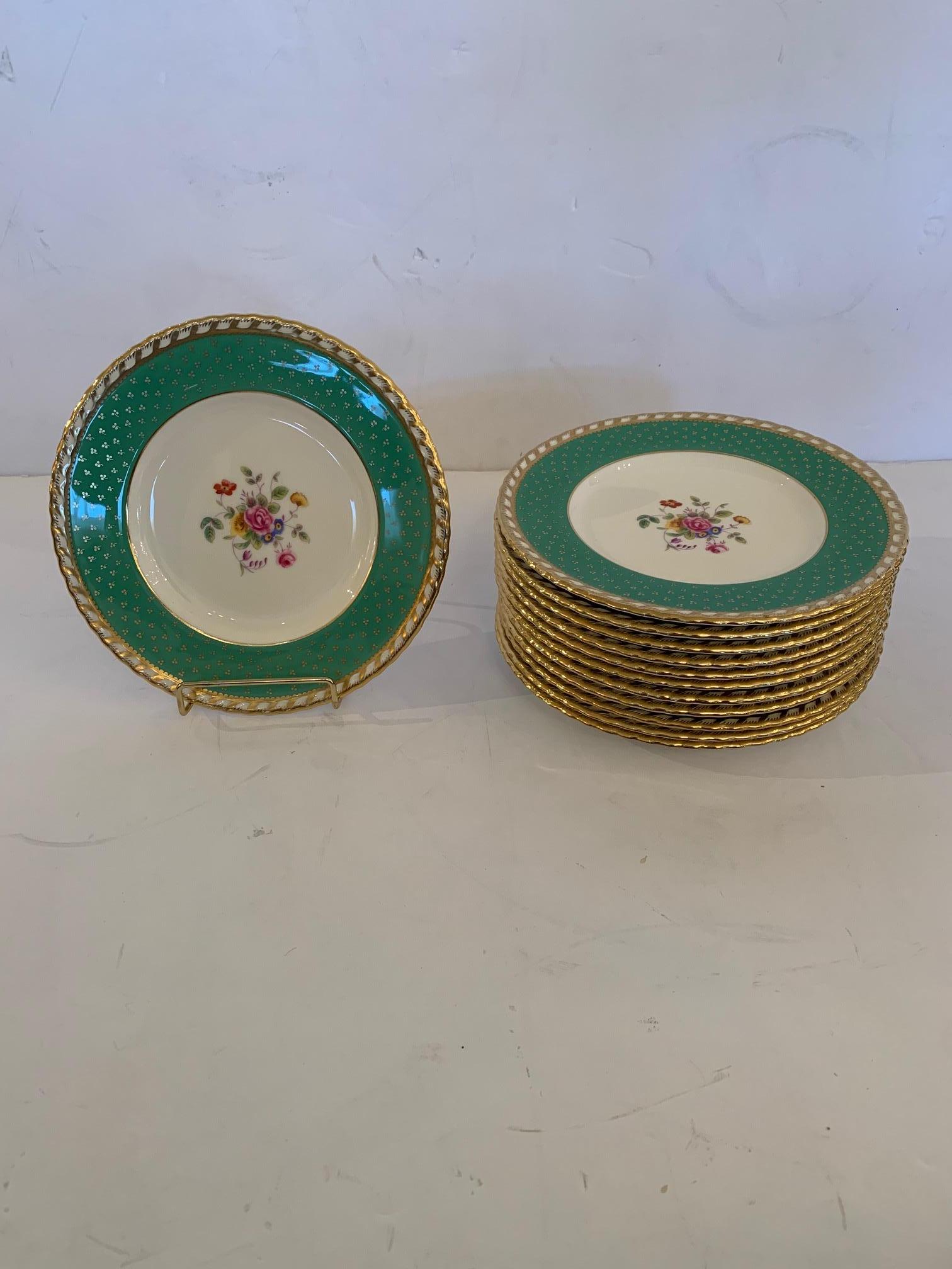 A gorgeous set of 12 dessert sized Tiffany china plates having celadon green and gold borders, cream centers and lovely floral central decoration.