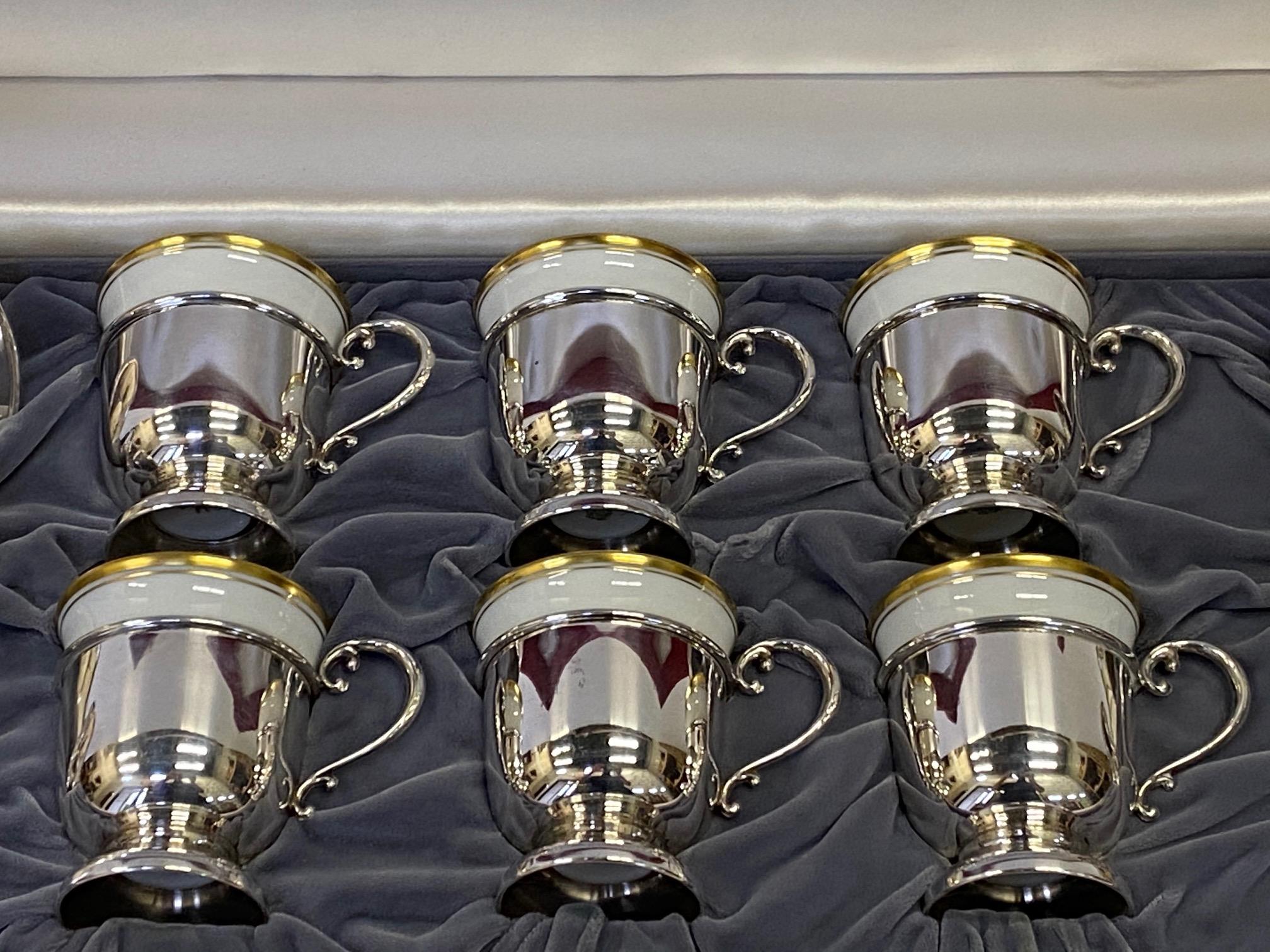 Fit for royalty, a set of vintage Cartier sterling silver and German porcelain demitasse cups and saucers in original luxe box. Measures: Saucers 3.75 diameter, 1/2
