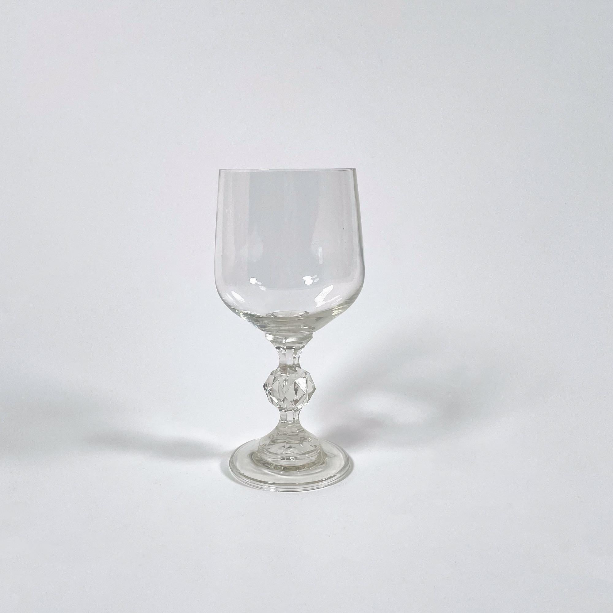 Discover a beautiful set of six vintage glasses, crafted from high-quality glass and dating back to the stylish 1960s. Standing at a height of 15.5 cm with a top and base diameter of 6.5 cm, these glasses exhibit a timeless elegance that will