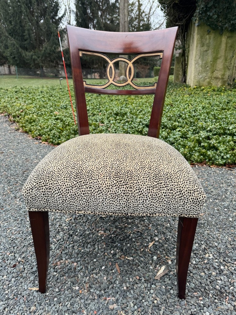 Superbly elegant set of 8 Biedermeier inspired dining chairs having stunning glossy mahogany frames with gilding on the overlapping circle decoration on the backs.  Chic leopard pattern silk velvet upholstery.  Two armchairs and 6 side chairs.  arm