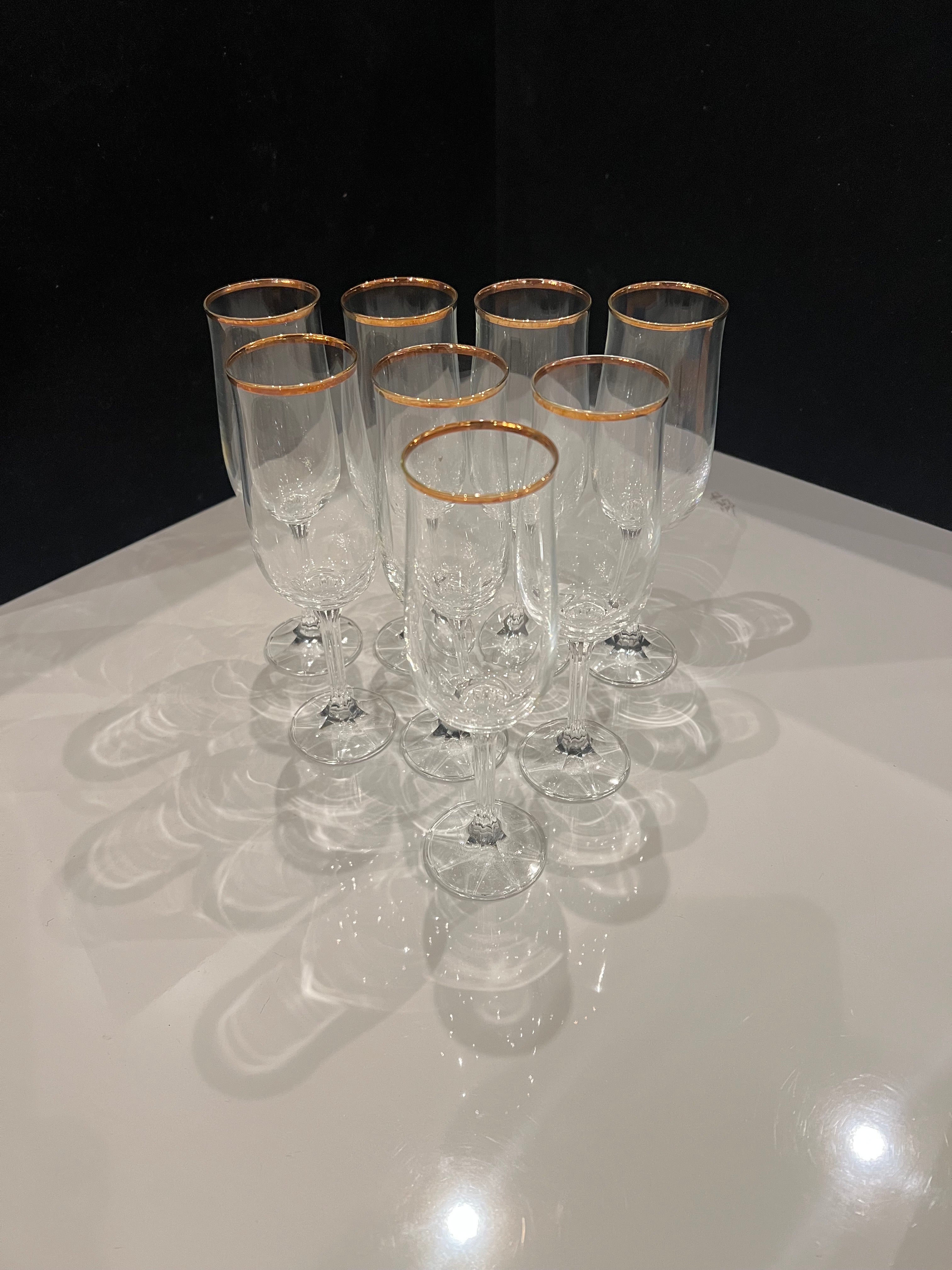 Beautiful elegant gorgeous fluted champagne glasses excellent condition with gold rim set of 8 .