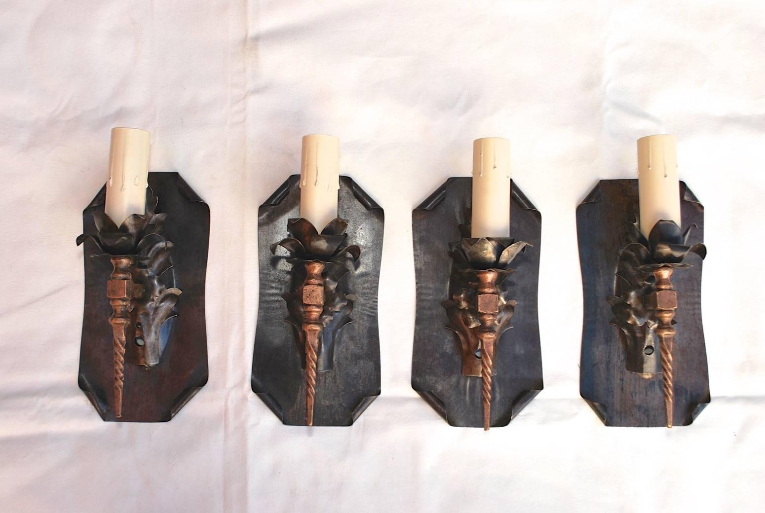 An elegant set of four wrought iron sconces, the patina is much nicer in person, price is for the set of four.

 