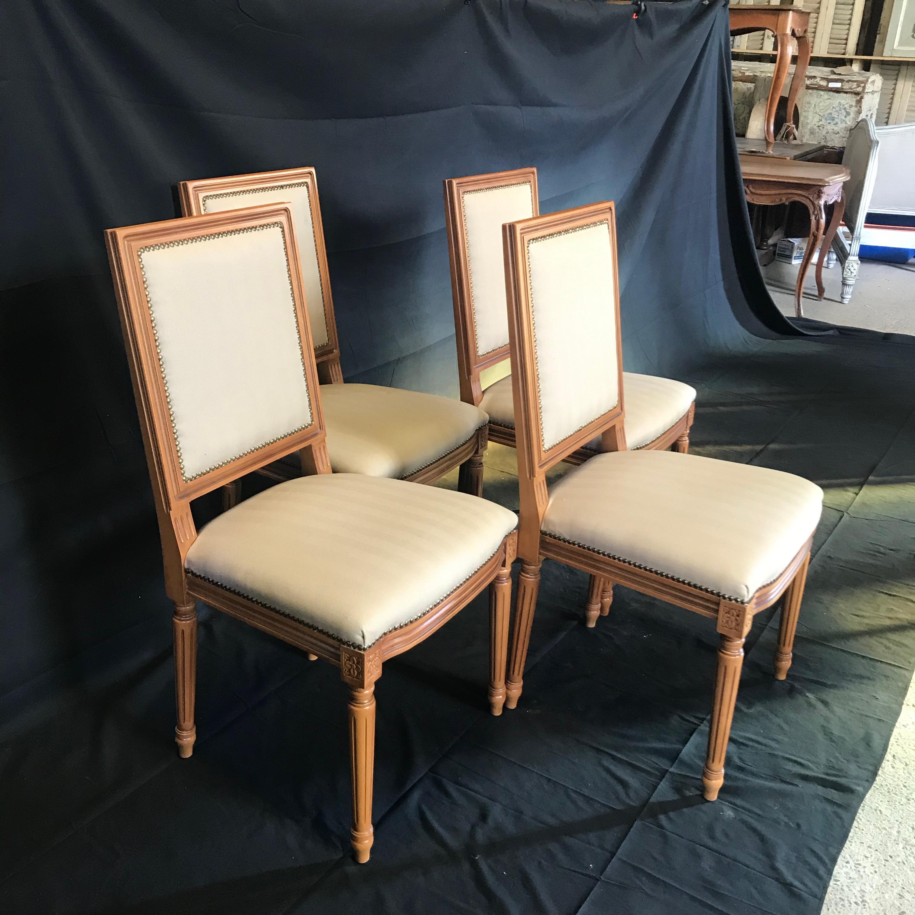 Set of four French Louis XVI style chairs with walnut frames with lovely fluted legs with classic cubic blocks decorated with florets. Upholstered in beige fabric and finished with decorative tacking typical of the period.

#4957.


 