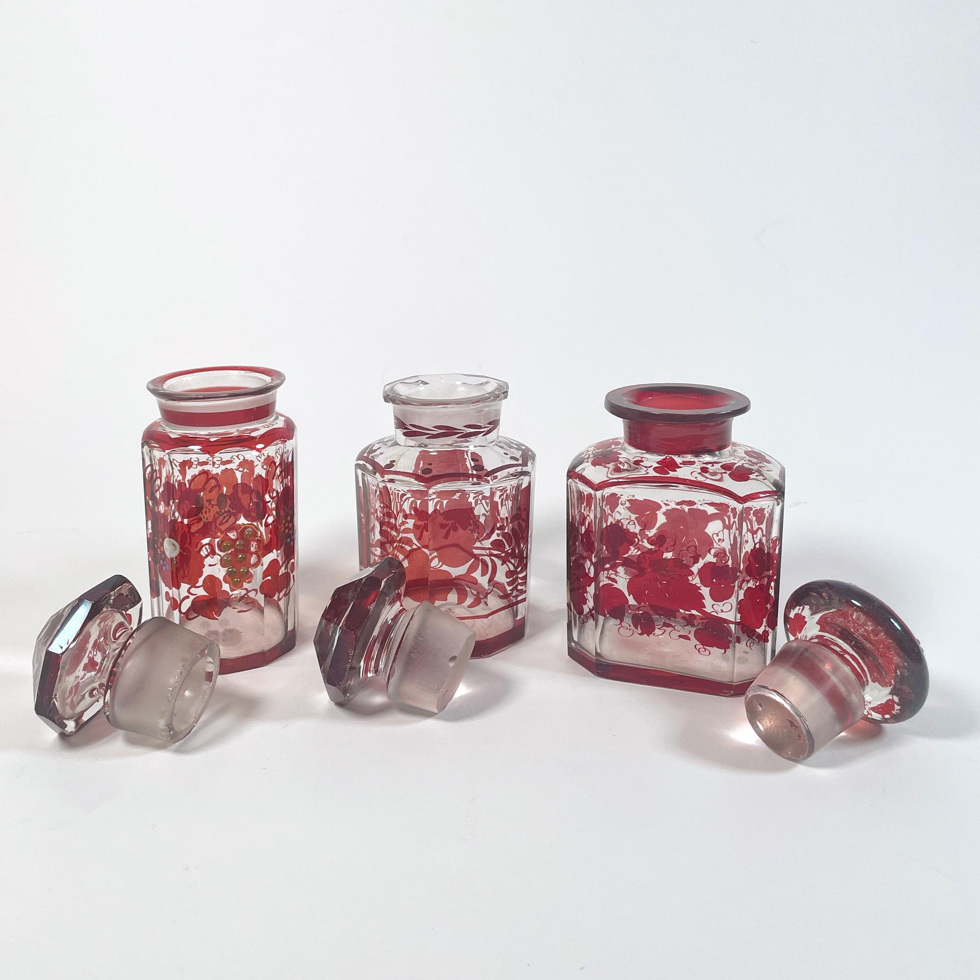 Elegant Set of Three 1940s Red Glass Bottles with Applied Relief Decoration In Good Condition For Sale In PARIS, FR